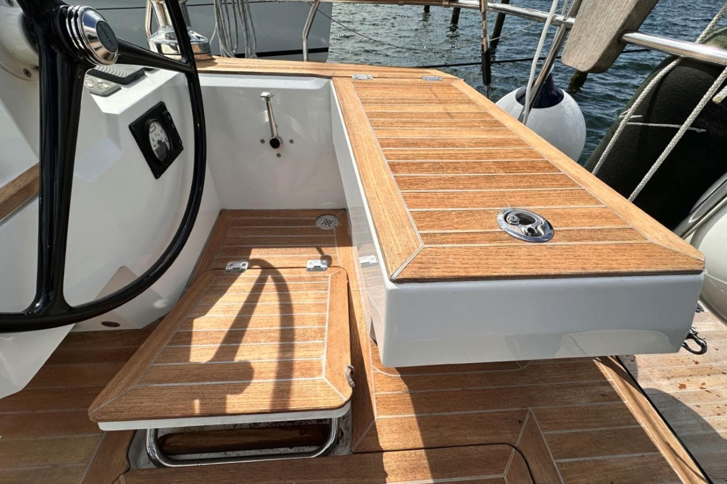 Wauquiez Pilot Saloon 48 cockpit with teak flooring, 2021 model, featuring steering wheel and seating.
