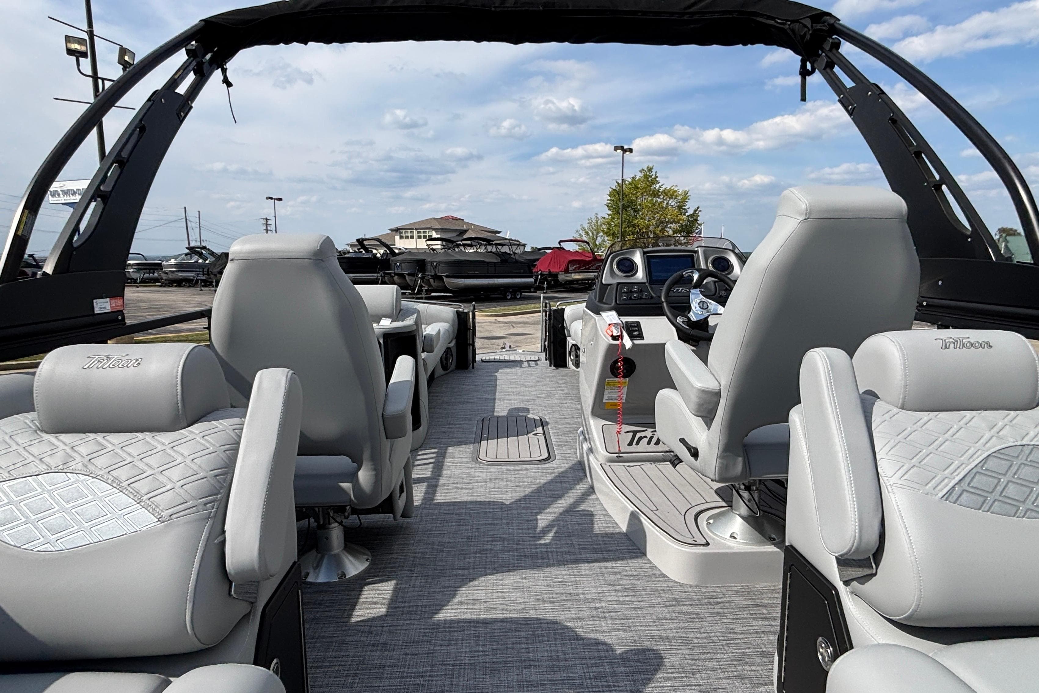 2026 JC Sporttoon 26TT boat interior with luxurious seating and modern dashboard.