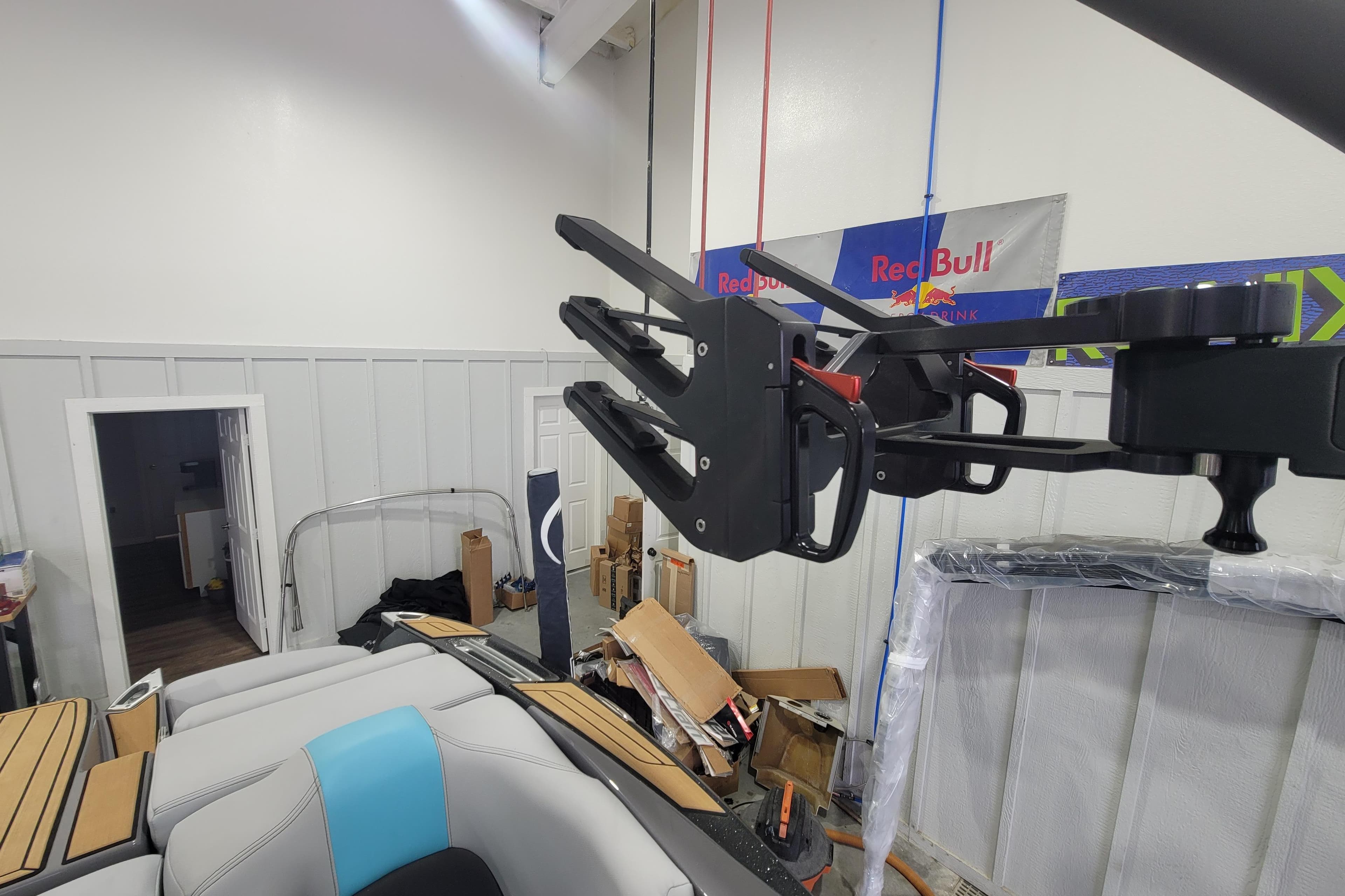 2022 MasterCraft X22 boat interior with wakeboard rack in a garage setting.