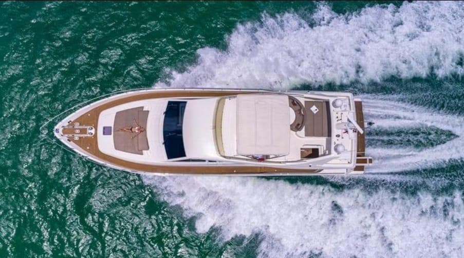 Aerial view of 2005 Ferretti Yachts 680 cruising on open water.