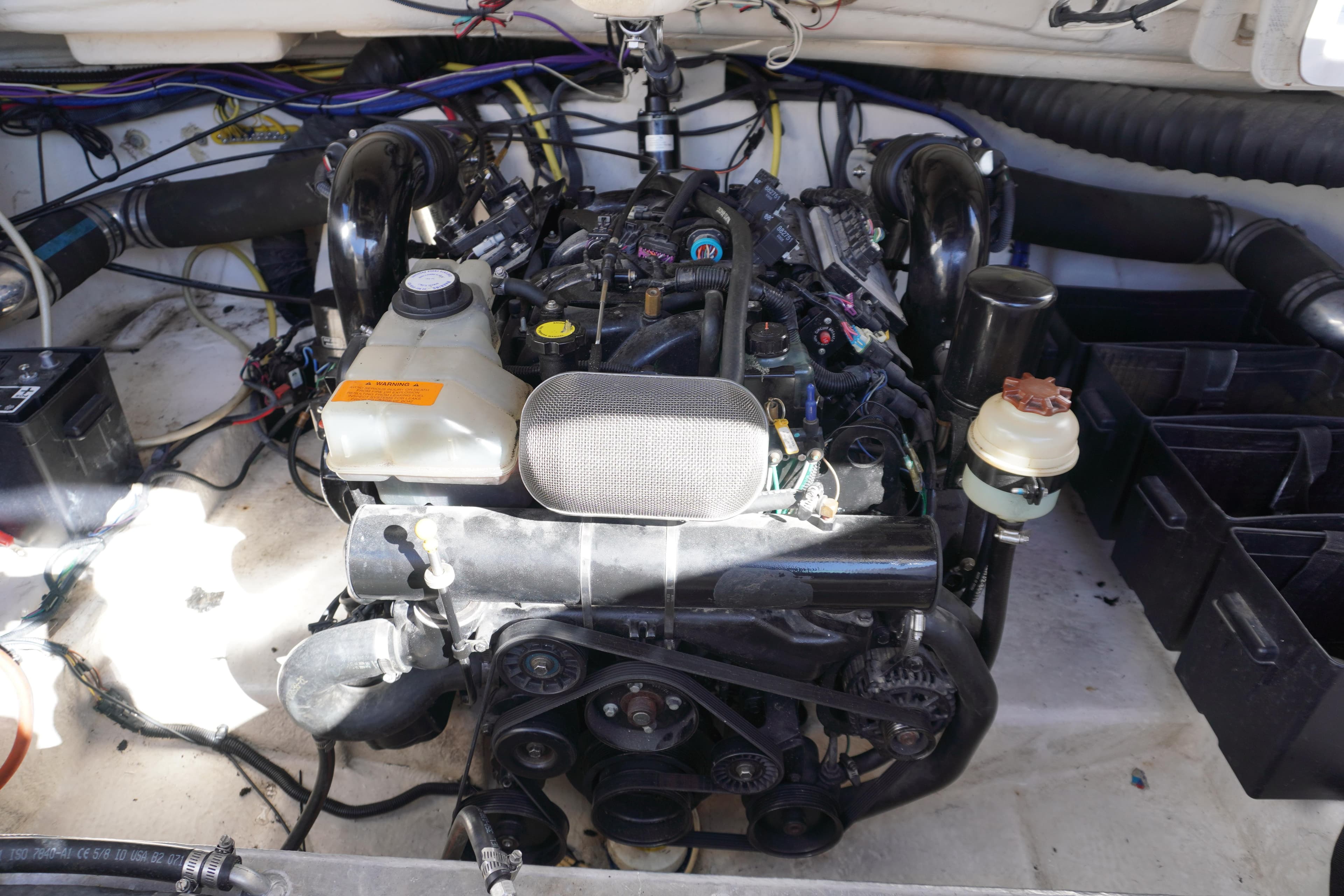 Engine compartment of a 2006 Chaparral 280SSi boat, showcasing mechanical components.