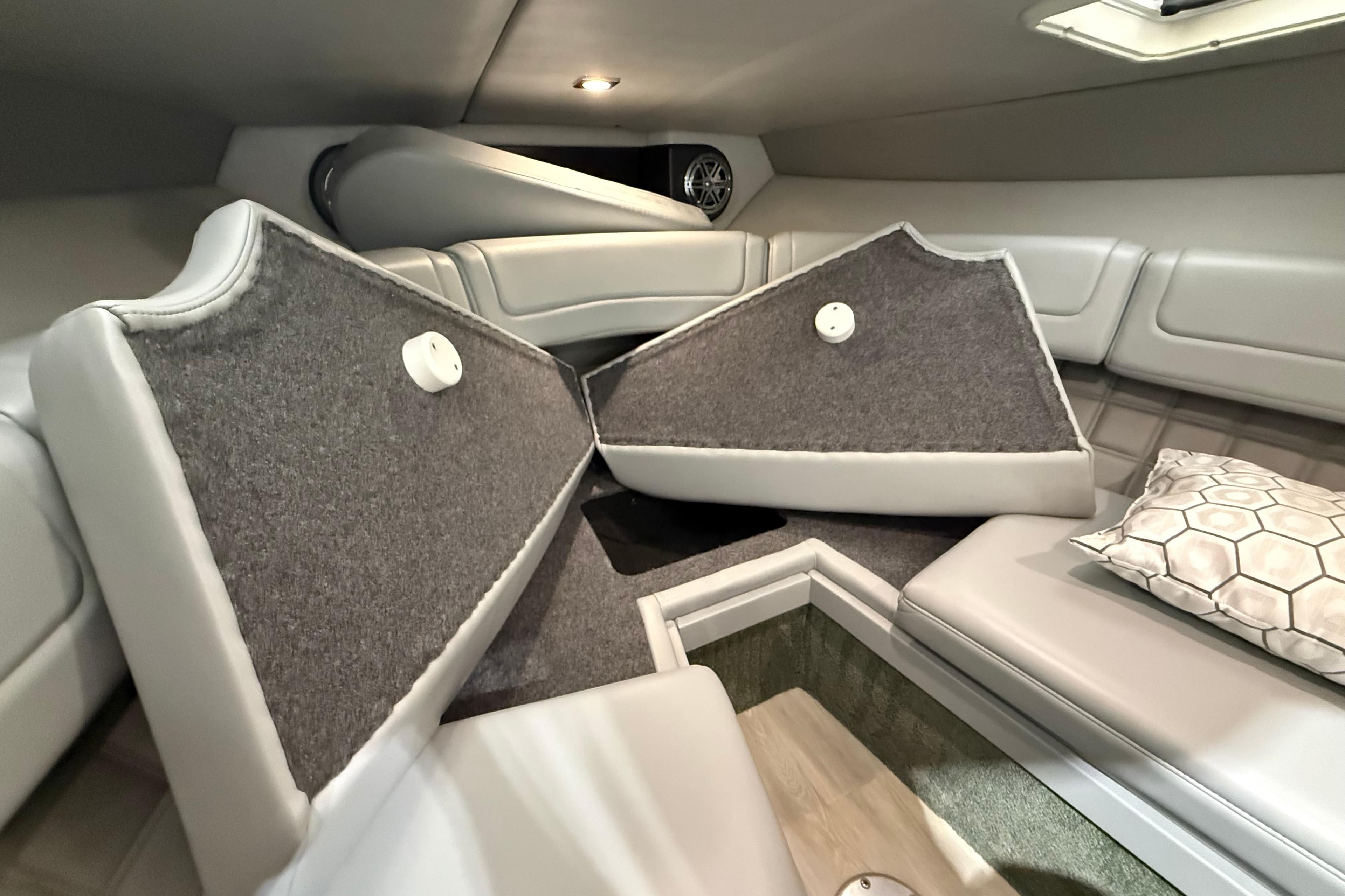 2018 Formula 270 Sun Sport cabin interior with cushioned seating and storage compartments.