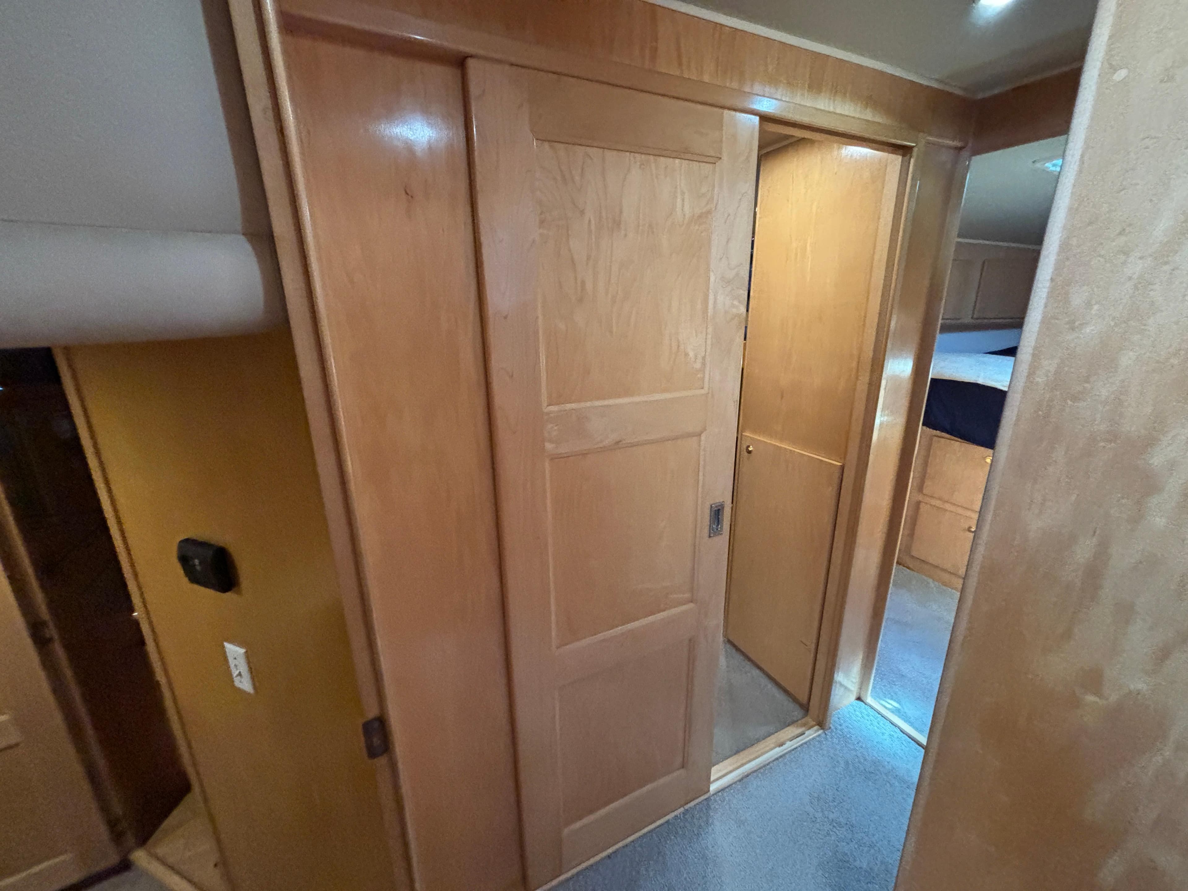 Interior of a 2000 Navigator 5300 RV with wooden sliding door and carpeted floor.