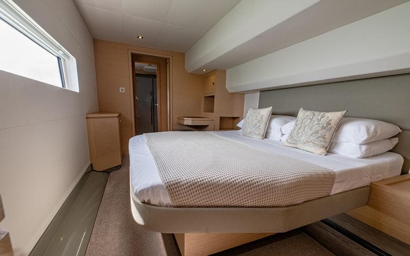 Luxurious bedroom interior of 2018 Fountaine Pajot MY44 yacht with modern design and cozy bedding.