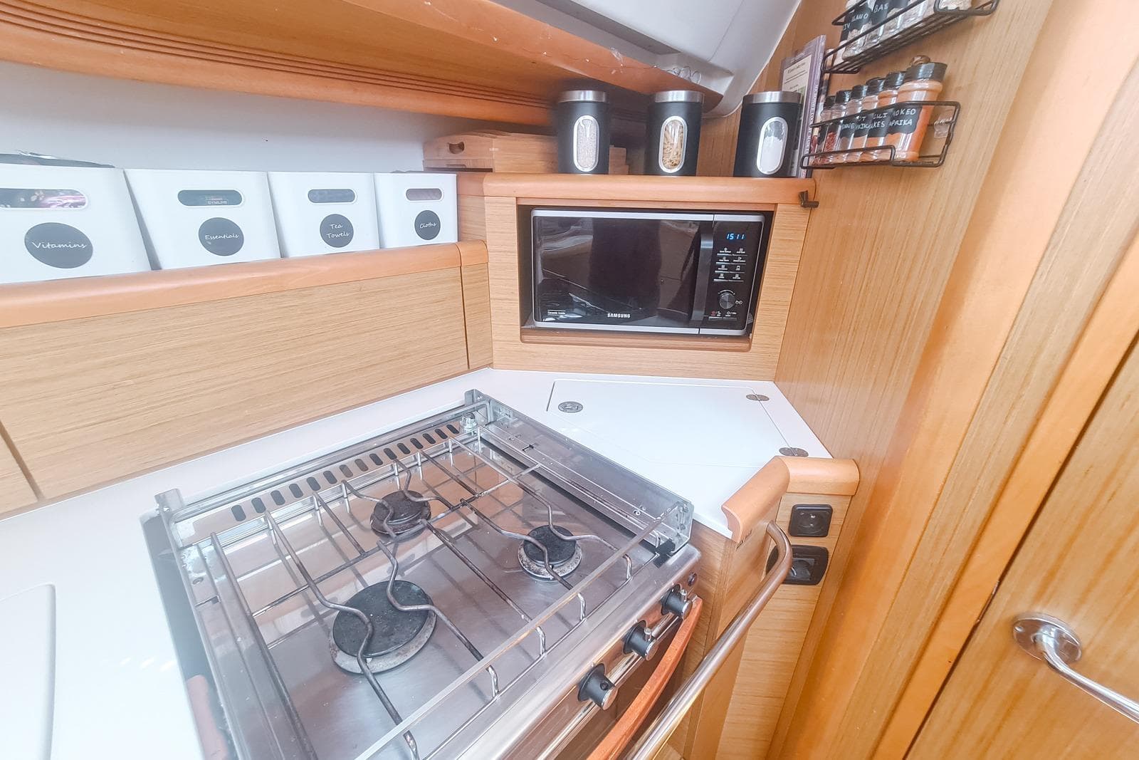 Galley kitchen in 2009 Jeanneau Sun Odyssey 50 DS yacht with stove and microwave.
