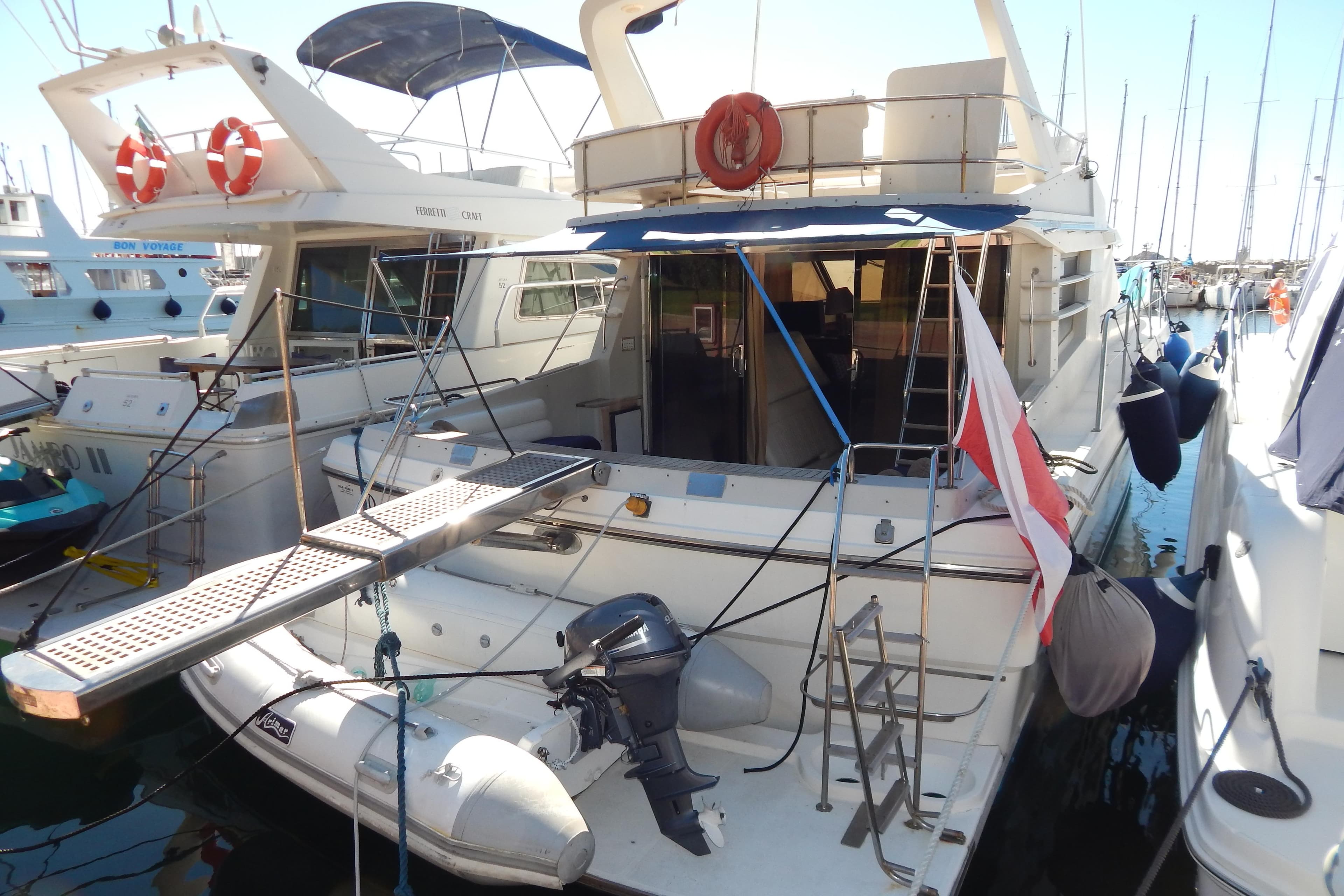 1992 Fairline 50 yacht docked at marina, featuring rear deck and lifebuoys.