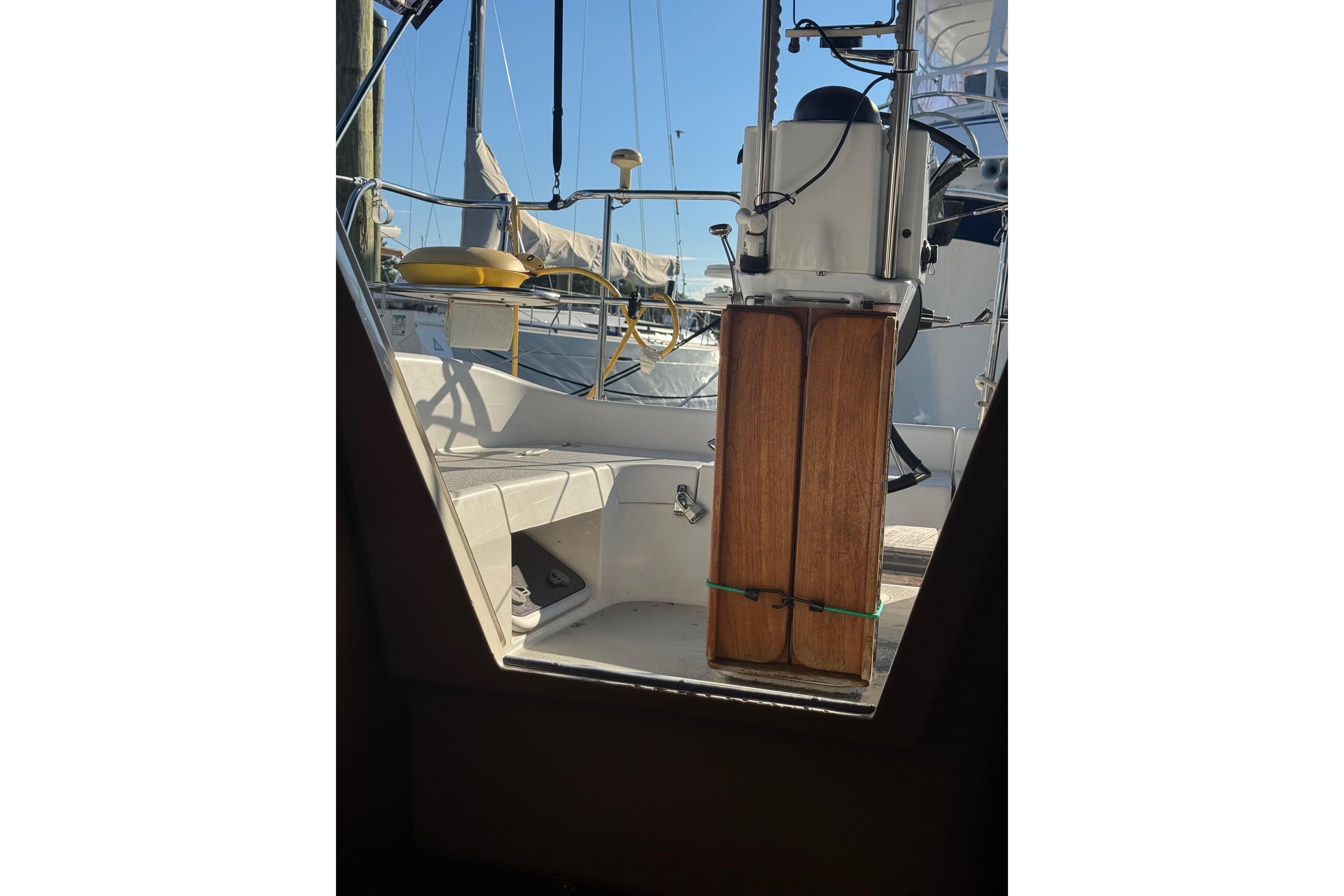 Interior view of a 2006 Catalina 309 sailboat cockpit with wooden details.