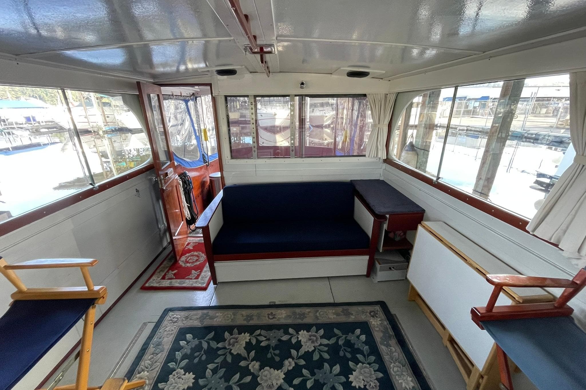 Interior of a 1947 Matthews De Luxe Sedan boat with seating and nautical decor.