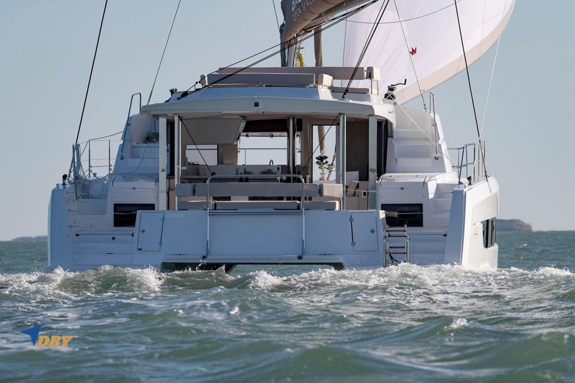 2025 Bali 4.4 catamaran sailing on open water, rear view.