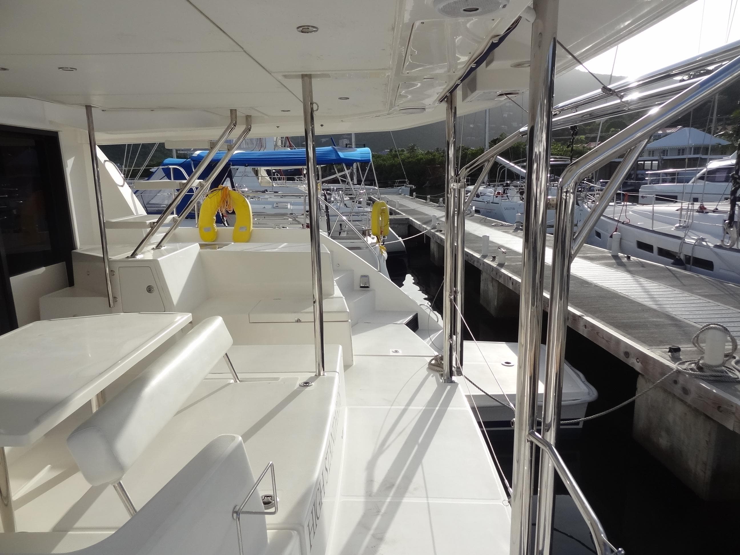 2017 Leopard 43 Powercat yacht docked at marina, featuring spacious deck and seating area.