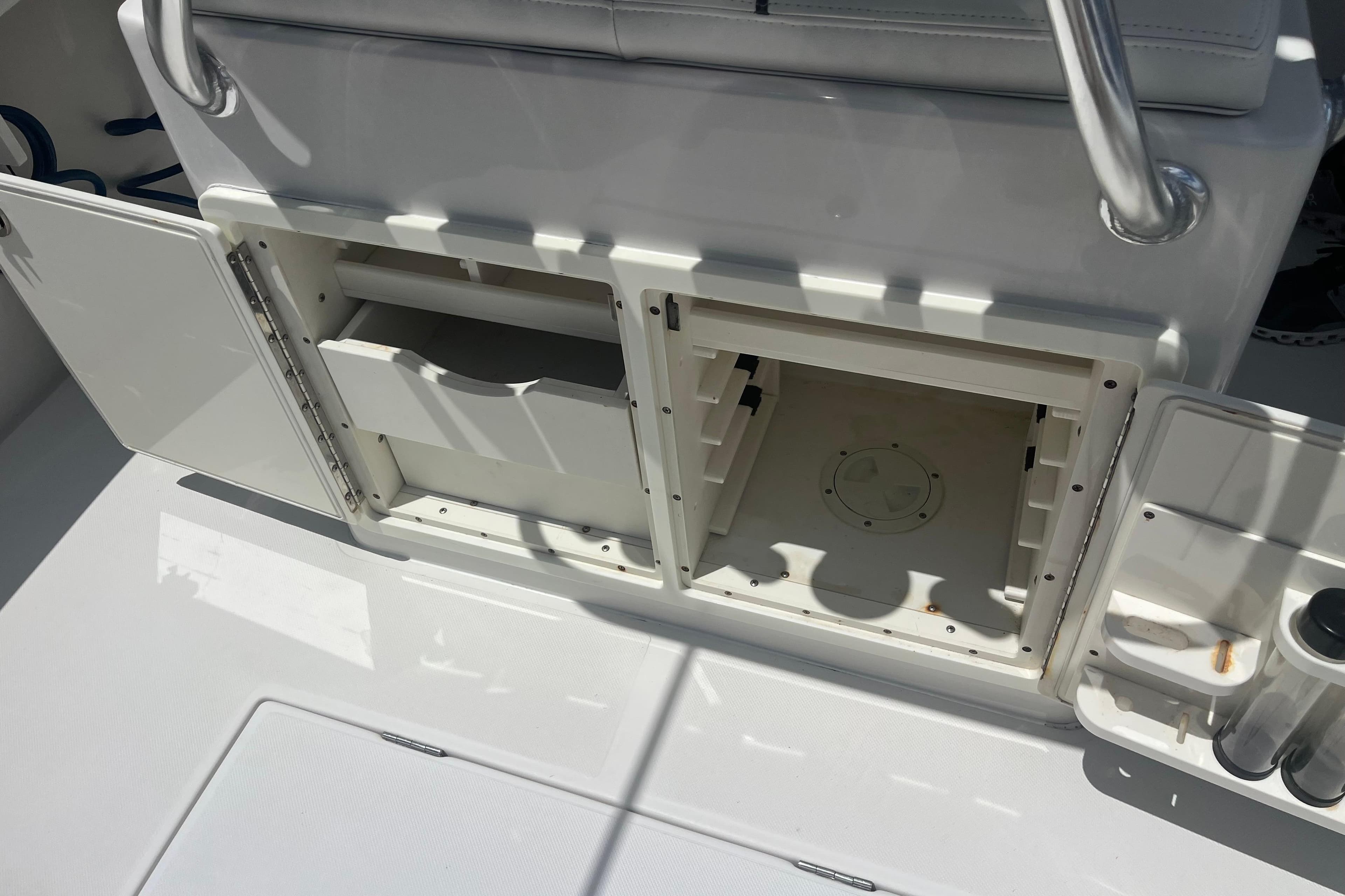 2015 Jupiter 26 FS boat storage compartments with open doors and visible interior.