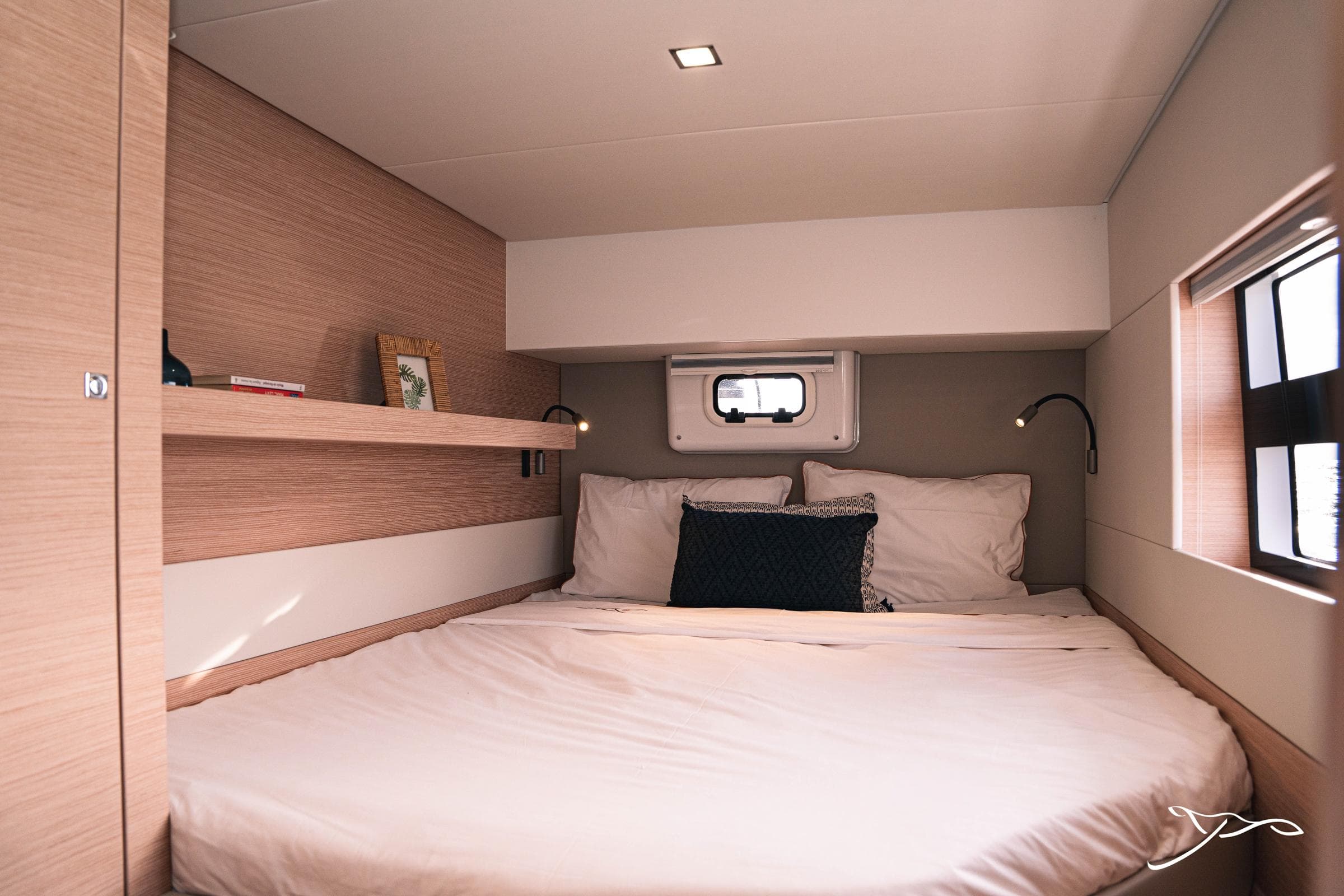Luxurious cabin interior of 2025 Nautitech 40 Open catamaran with cozy bedding and modern design.
