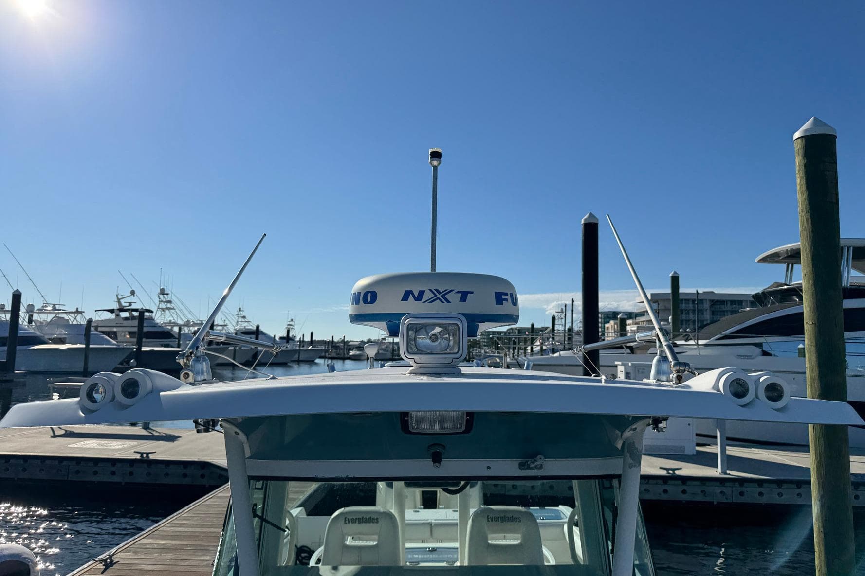 2008 Everglades 350 Center Console boat docked under clear blue sky.