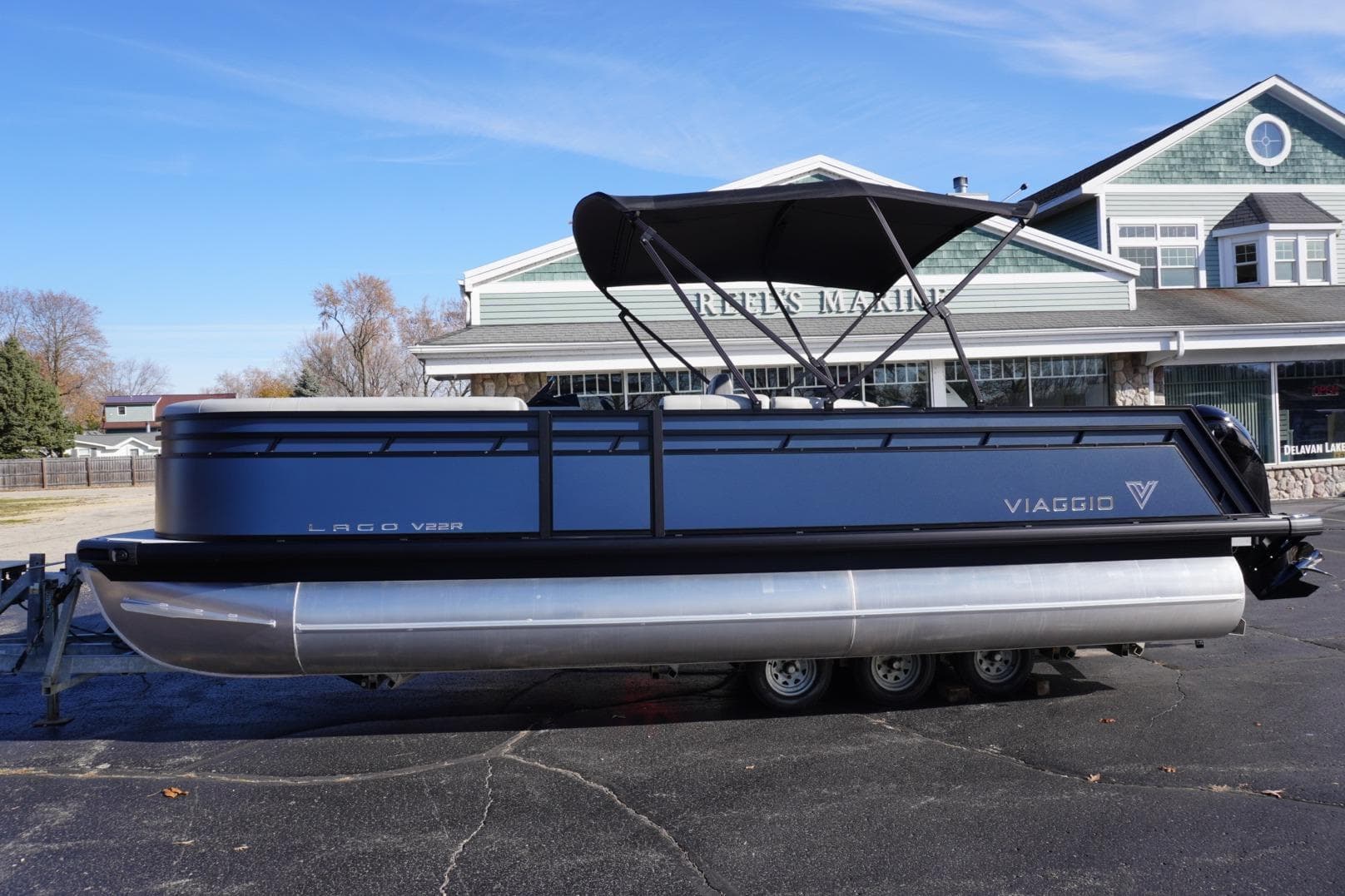 2026 Viaggio Lago V-R pontoon boat parked outside a marine dealership.