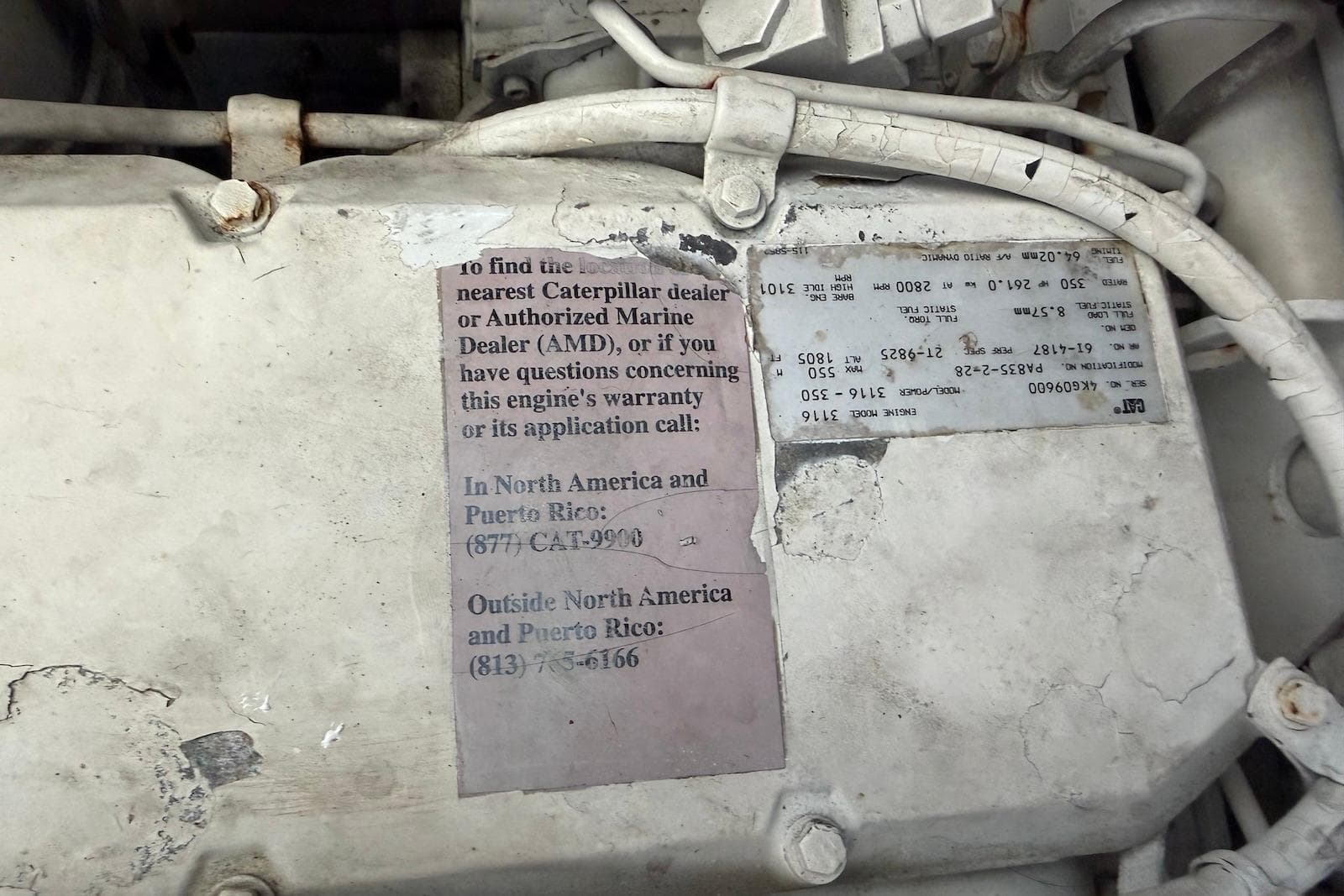 Engine compartment of a 2000 Sea Ray 410 Sundancer with Caterpillar warranty information.