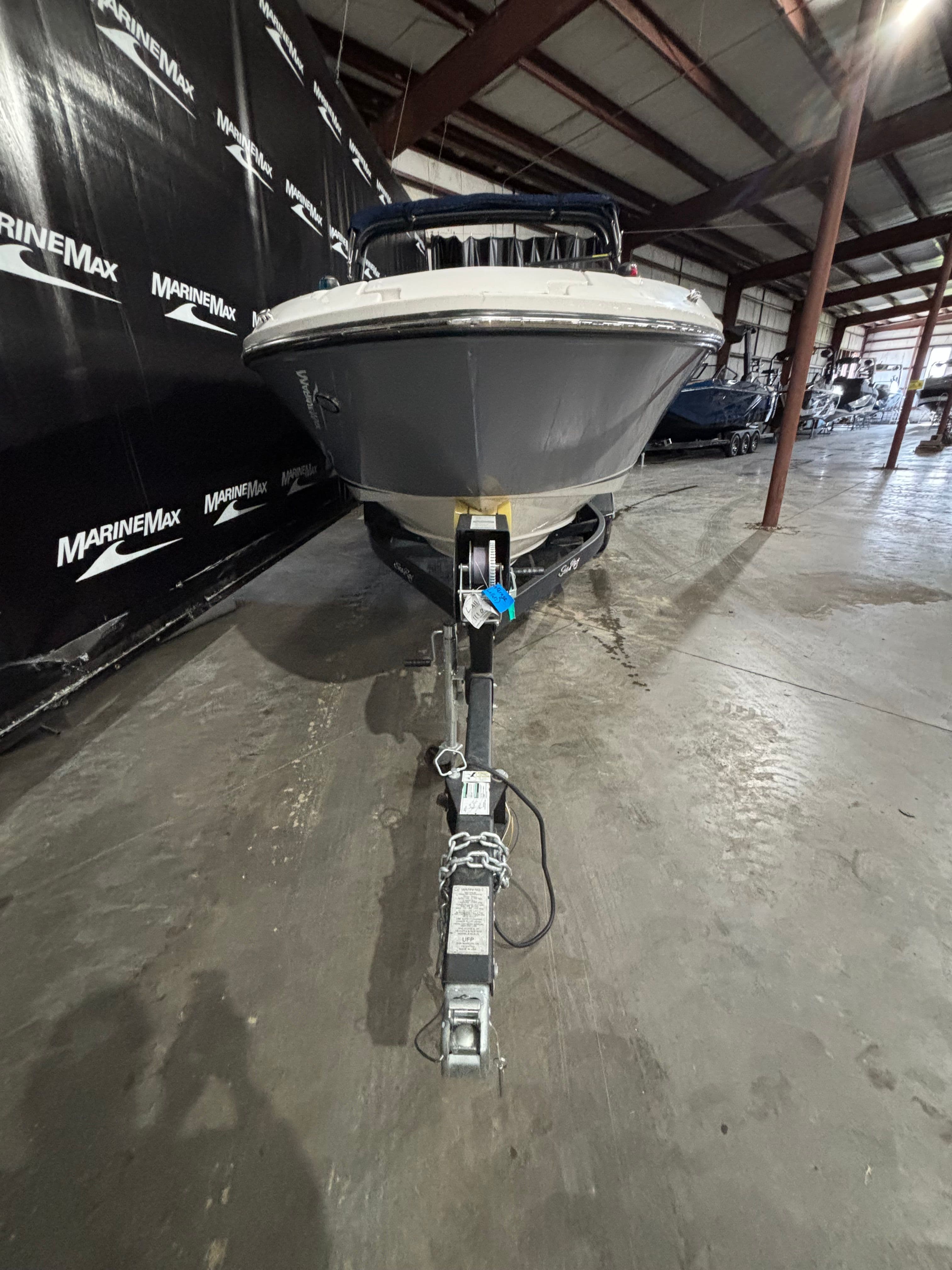 2018 Sea Ray SLX 230 boat on trailer in warehouse.