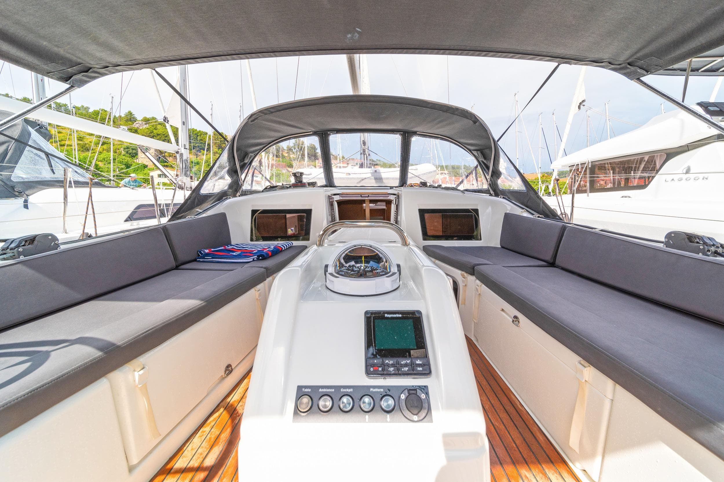 2023 Jeanneau Sun Odyssey 410 cockpit with seating, navigation controls, and canopy.