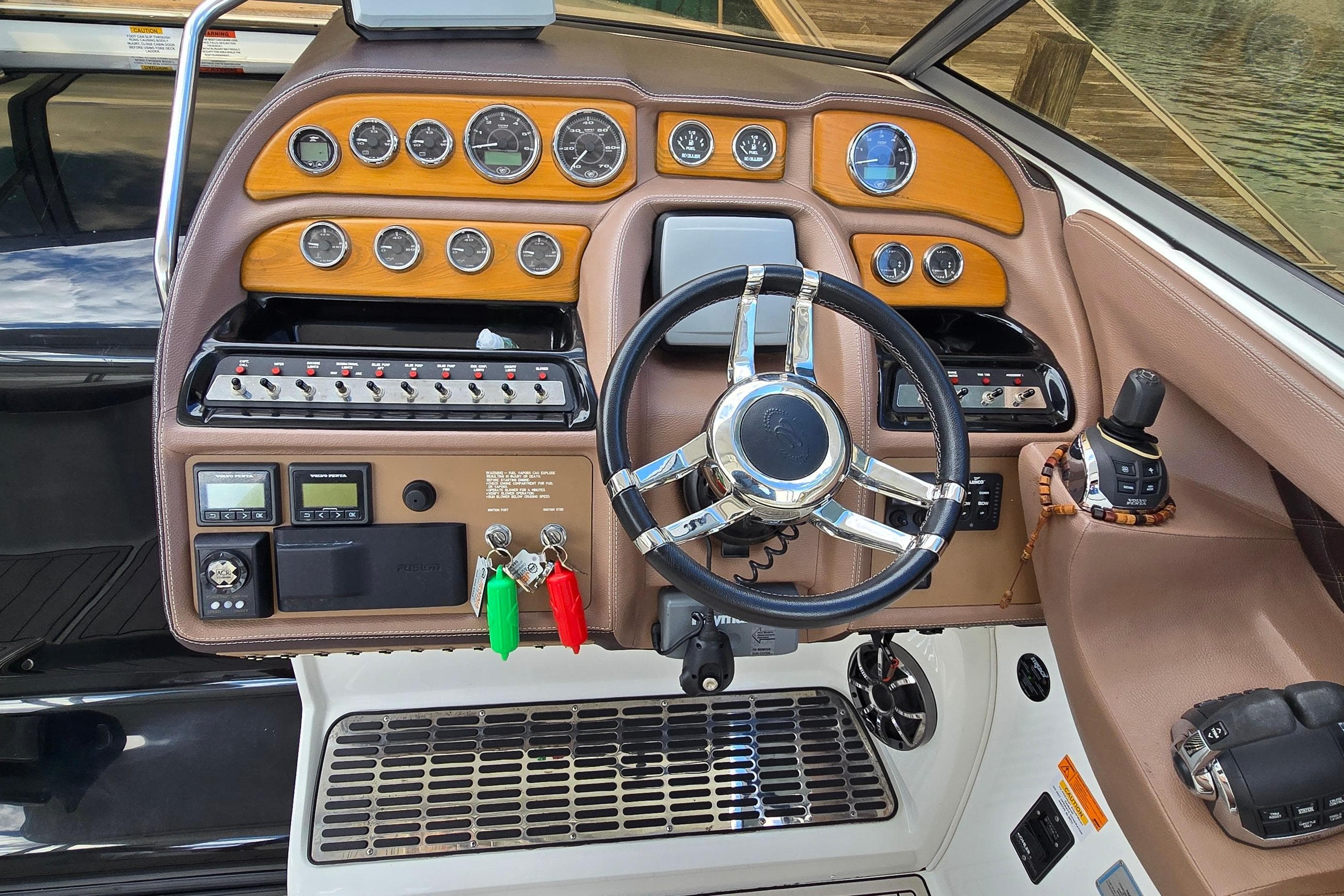 Dashboard of a 2011 Cobalt 323 boat with steering wheel and control panel.