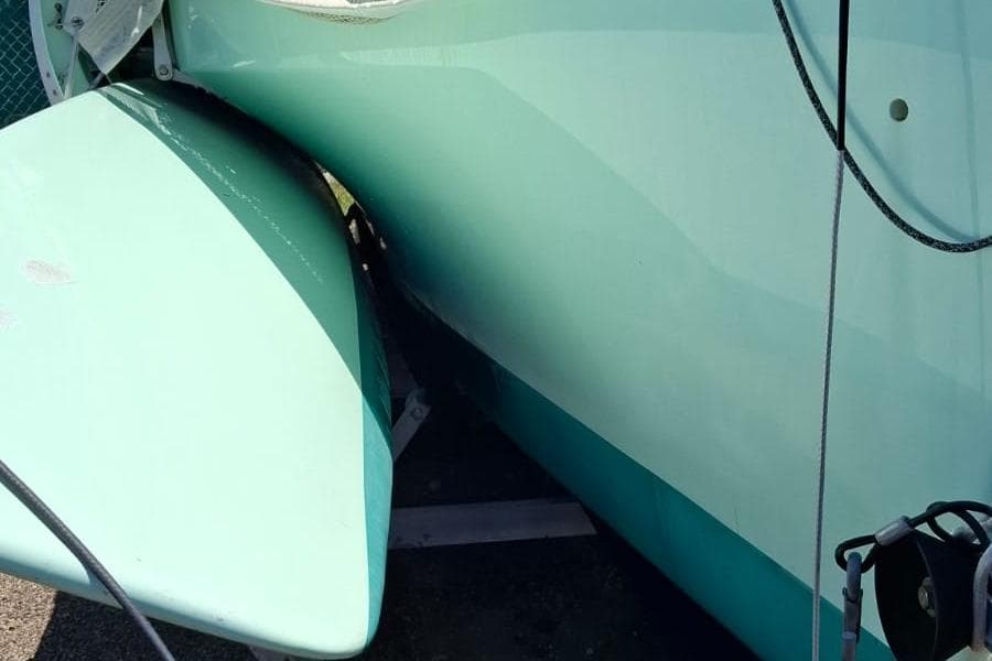 Close-up of a 2011 Custom Melvest Marine F-22 boat hull in light teal.