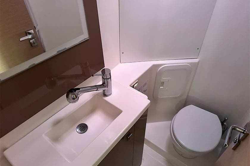 Modern bathroom in 2018 Fountaine Pajot Lucia 40 yacht, featuring sink and toilet.
