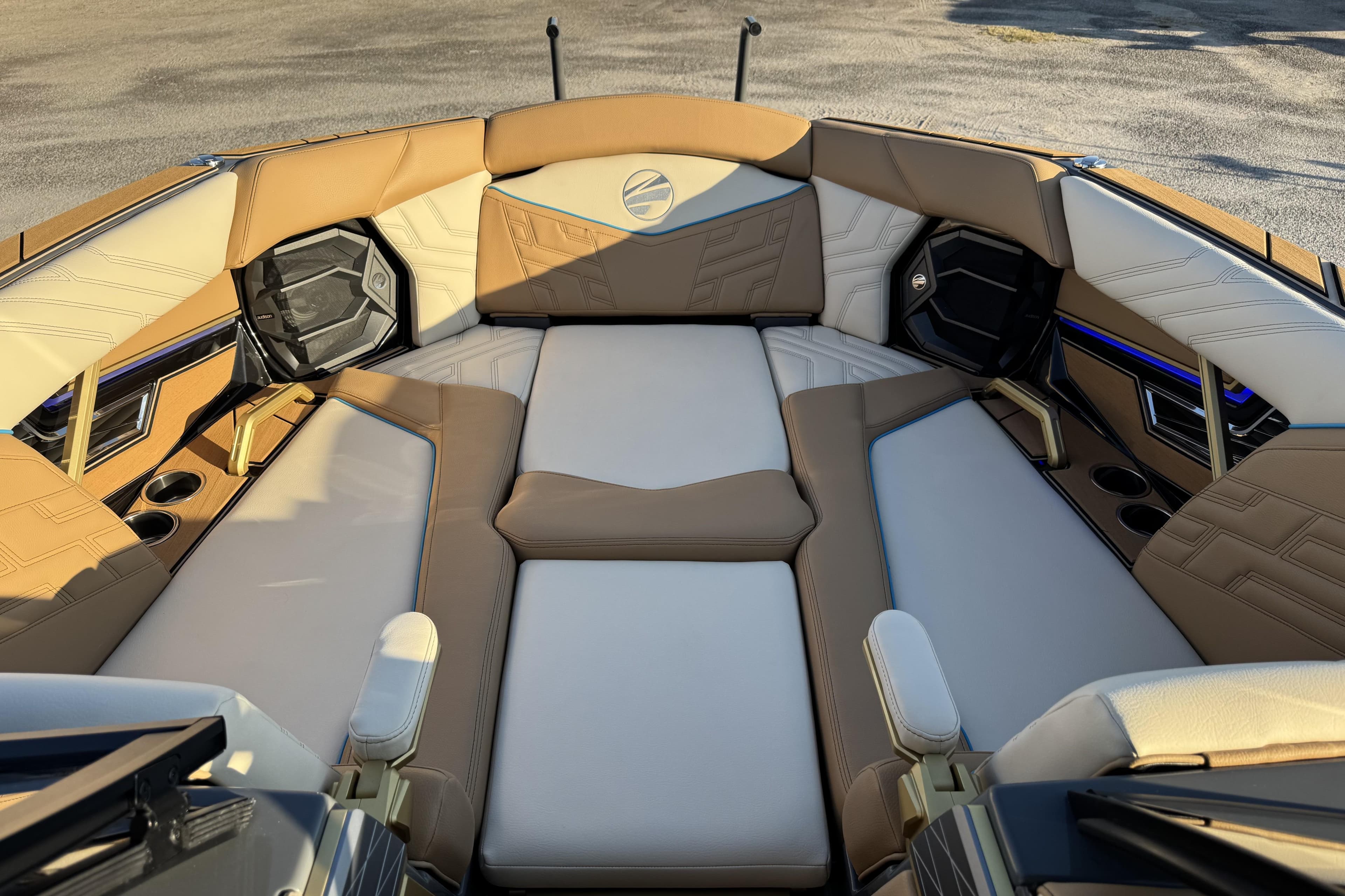 2026 Tigé Ultré 25ZX boat interior with luxurious tan and white seating, cup holders, and speakers.