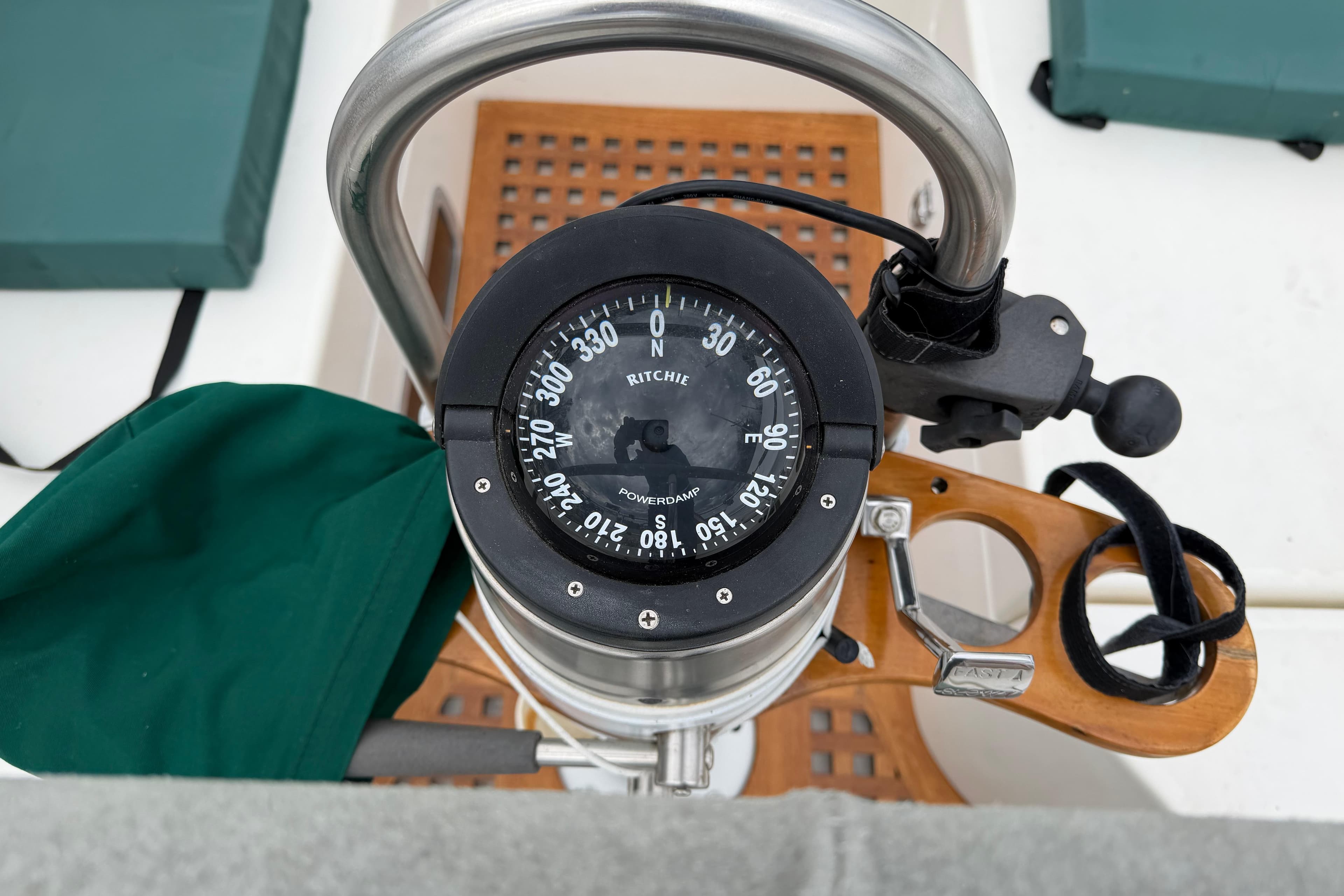 Compass on 1982 Sabre 34 sailboat helm, featuring wooden and metal elements.