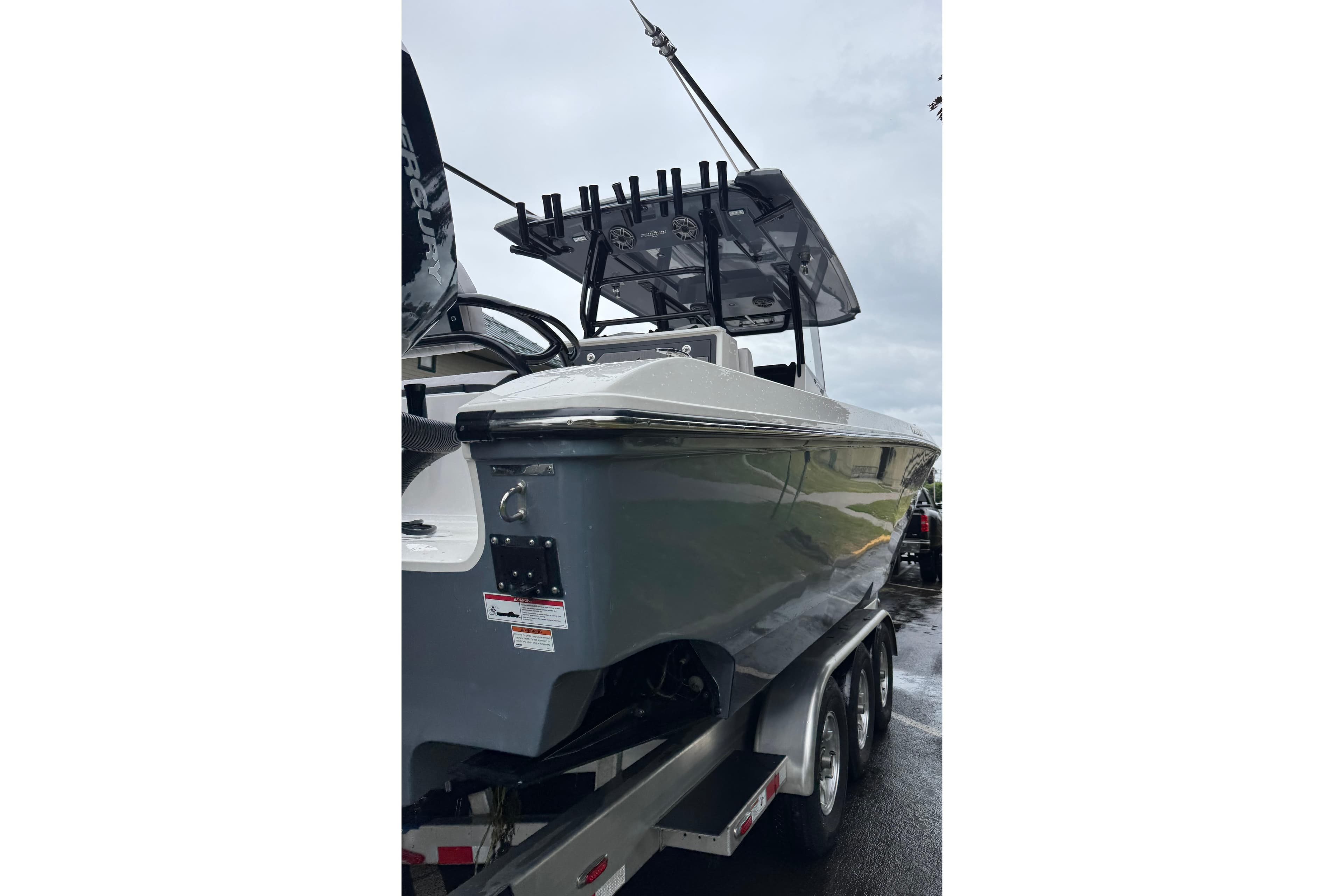 2023 Fountain 38 CC Tournament Edition boat on trailer, side view.