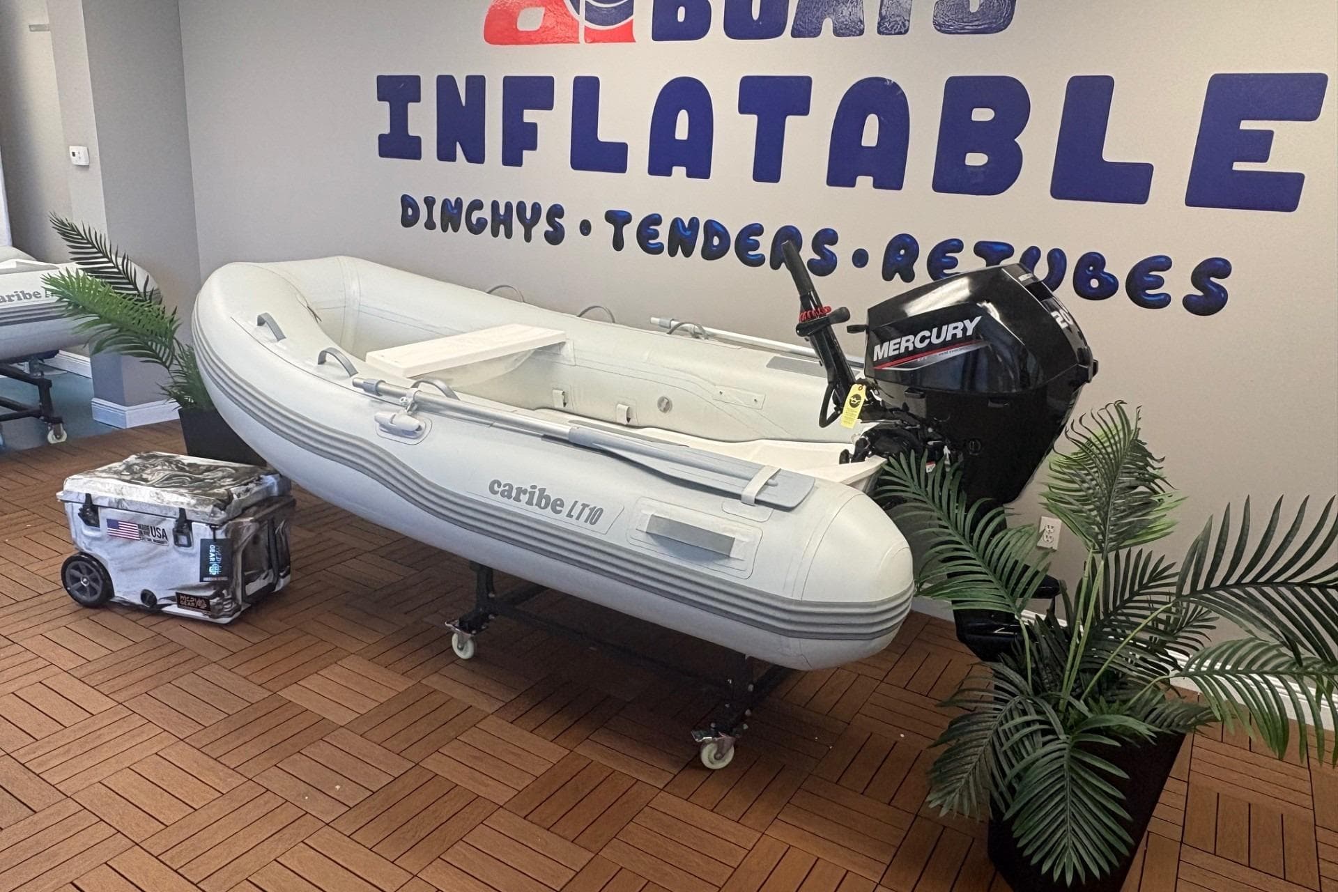 Inflatable Caribe L-10 boat with Mercury motor in showroom, 2025 model.
