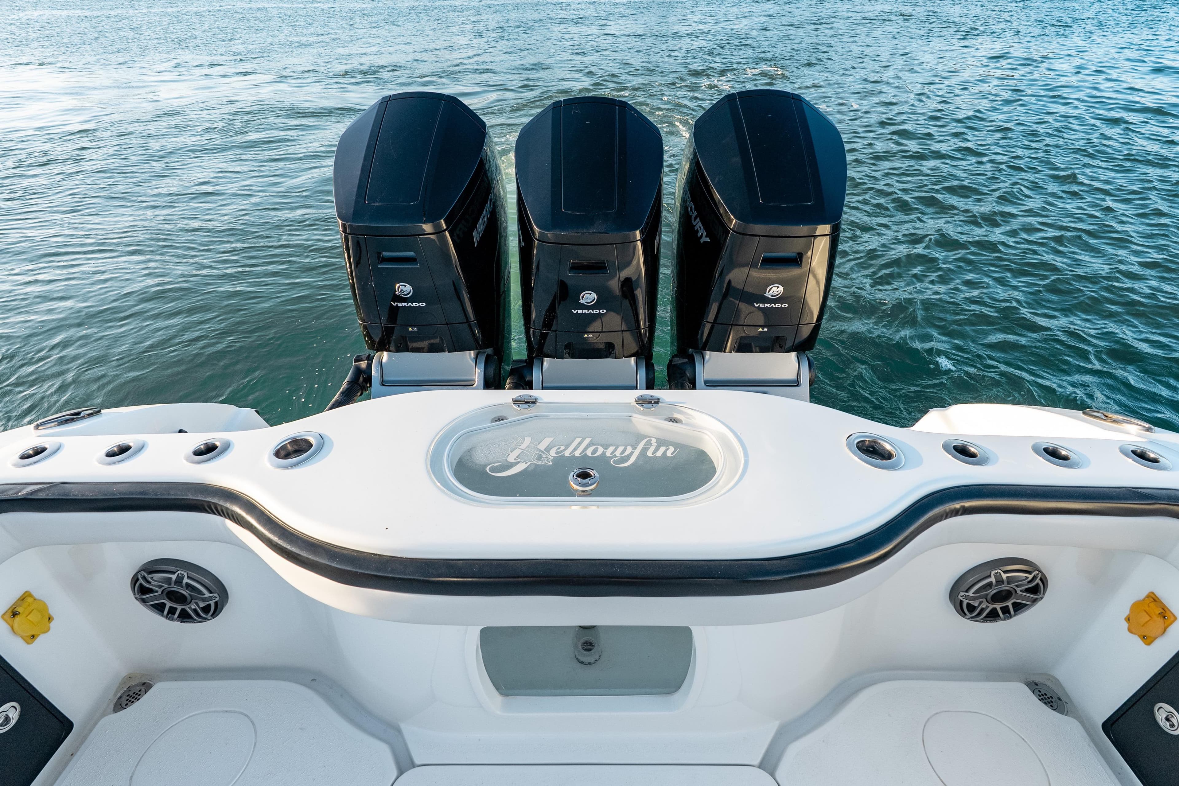 2023 Yellowfin 42 Offshore boat with triple outboard engines on the water.
