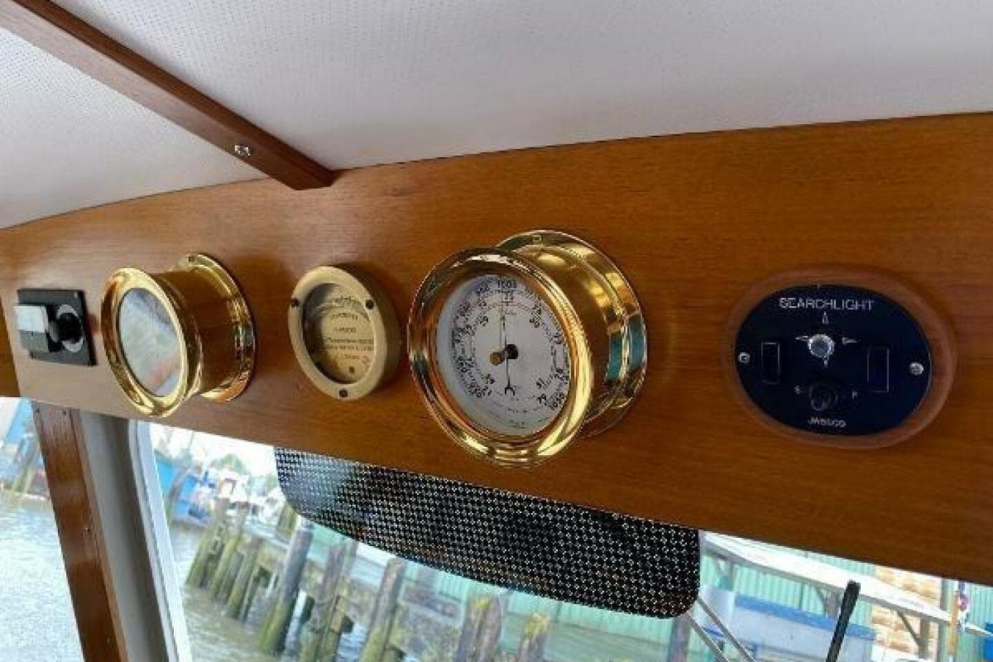 1973 Grand Banks 49 Alaskan dashboard with brass instruments and searchlight control.