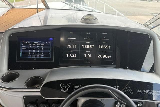 Dashboard of a 1999 Formula 400 Super Sport boat with digital displays and controls.