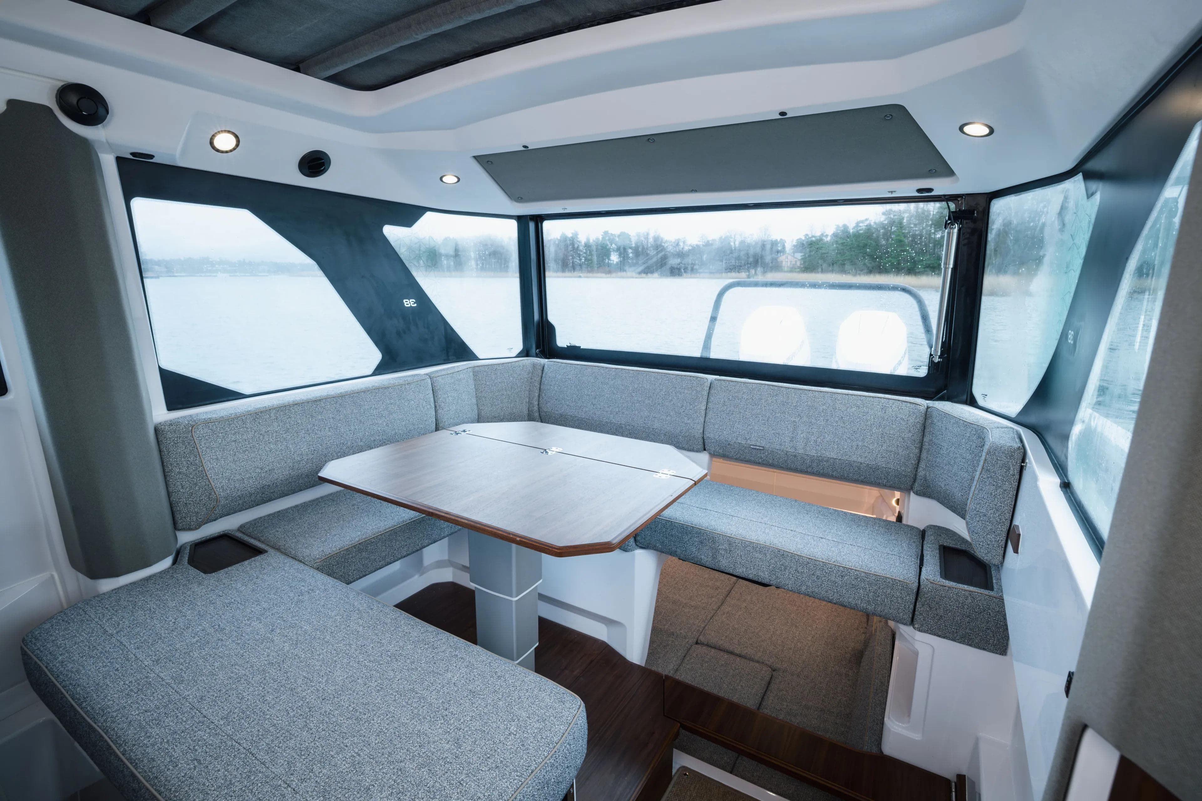 Interior of 2026 Axopar 38 Cross Cabin with modern seating and panoramic windows.