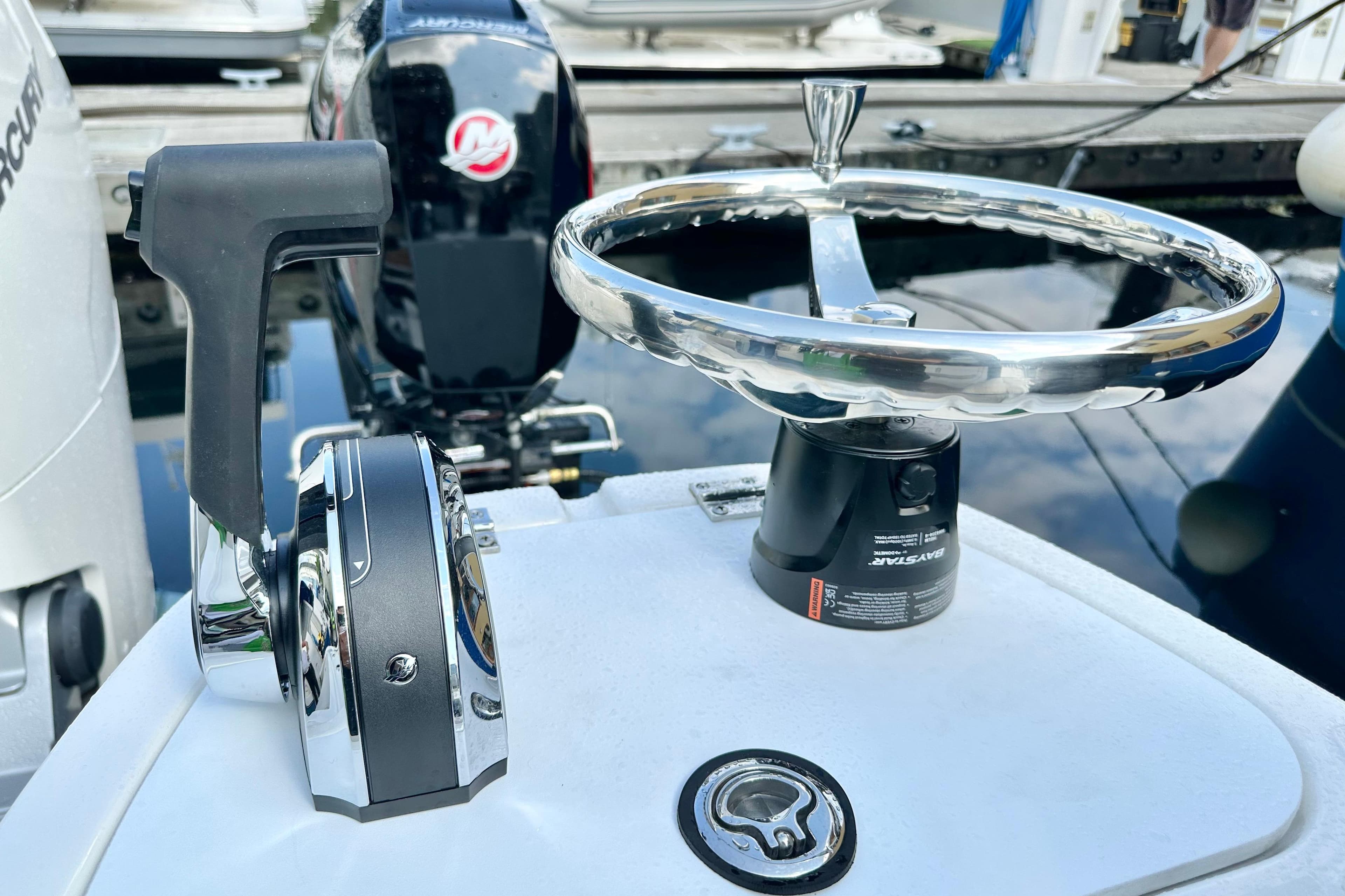 Control panel of 2025 Boston Whaler 365 Pilot House with steering wheel and throttle.