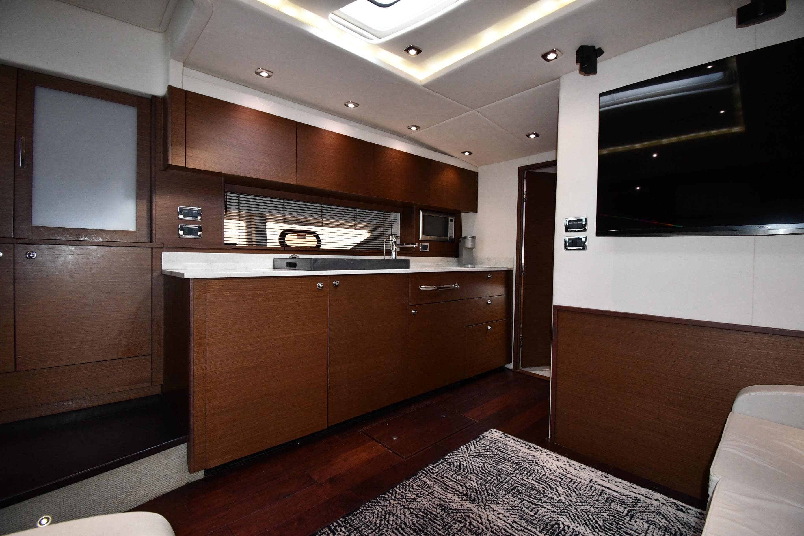 Luxurious interior of 2013 Sea Ray Sundancer 540 yacht with modern kitchen amenities.