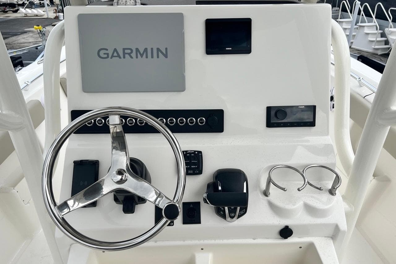 2026 Key West 239 FS boat dashboard with Garmin navigation system and steering wheel.