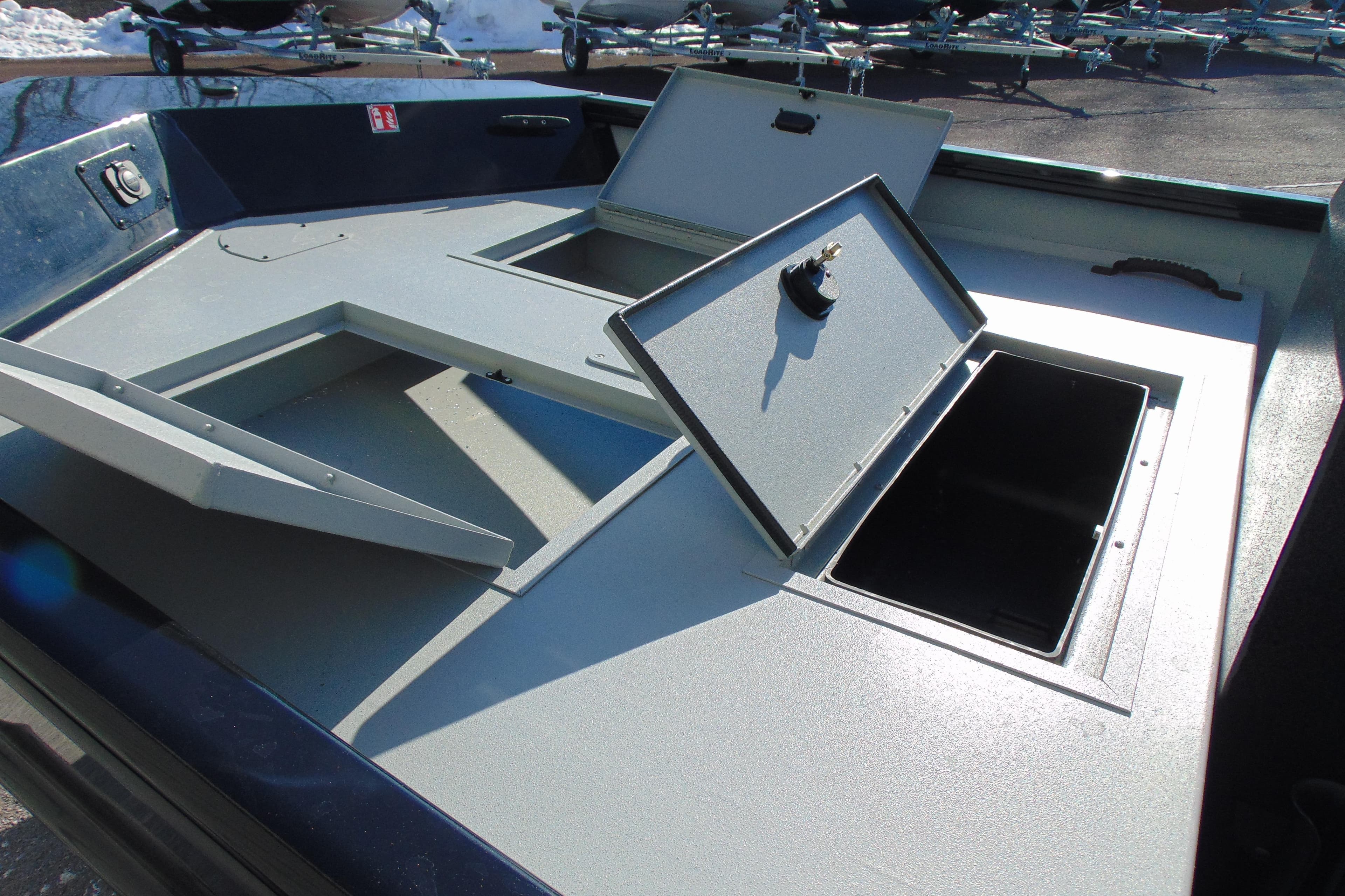 2026 Crestliner 1760 Retriever SC boat storage compartments open on deck.