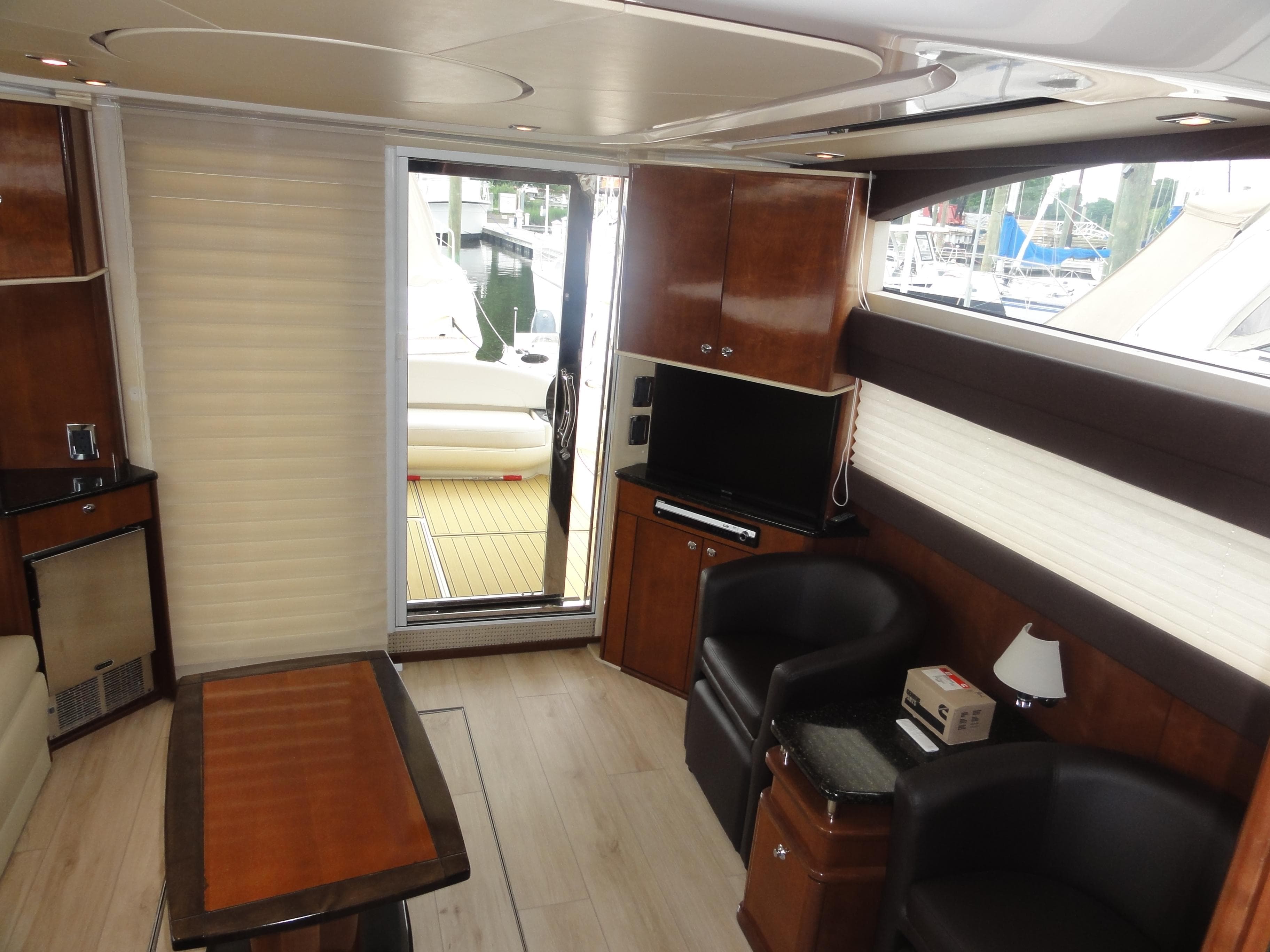 Luxurious interior of 2009 Meridian 441 Sedan yacht with modern furnishings and wood accents.