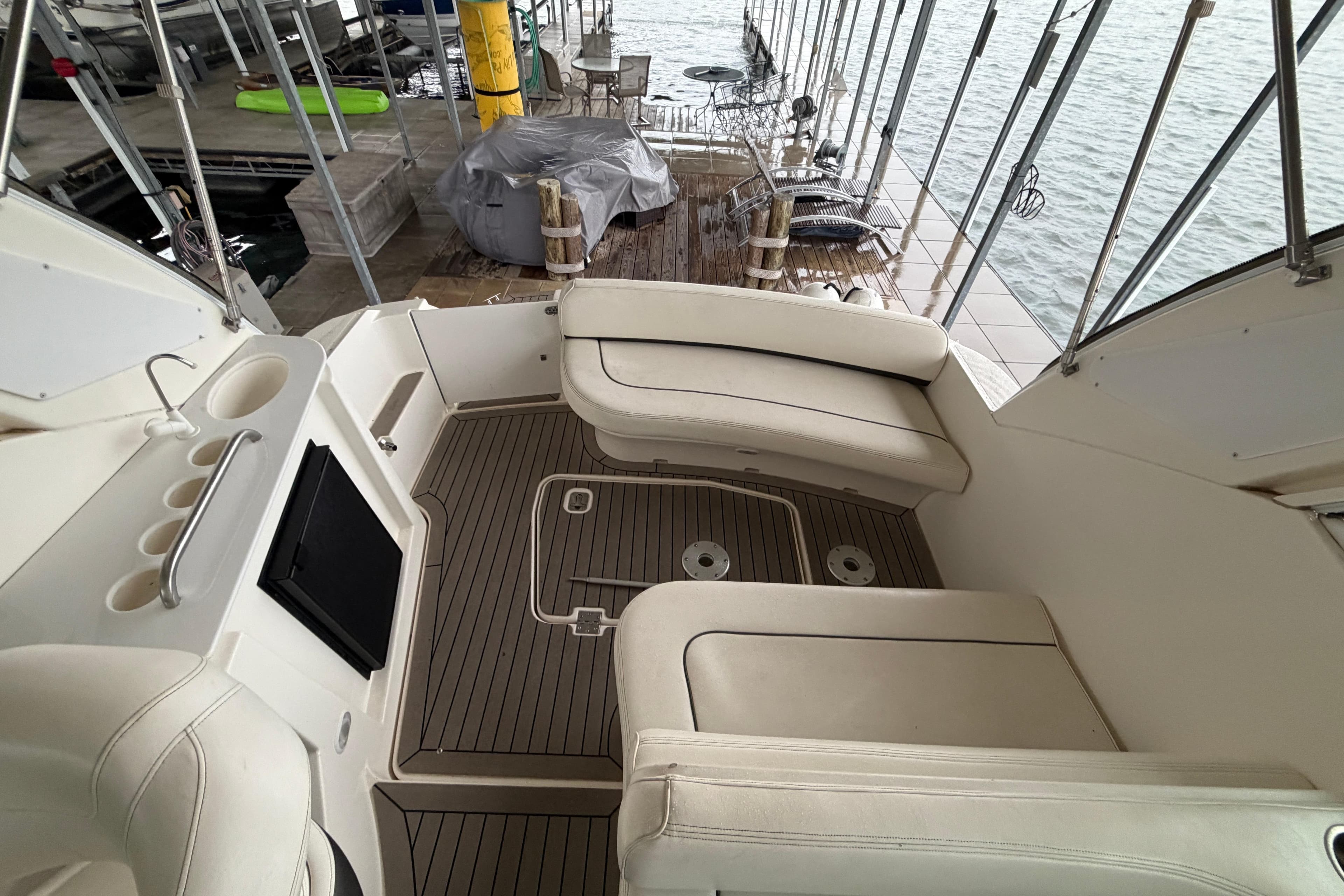 2006 Cruisers Yachts 300 Express interior with white seating and wood flooring.