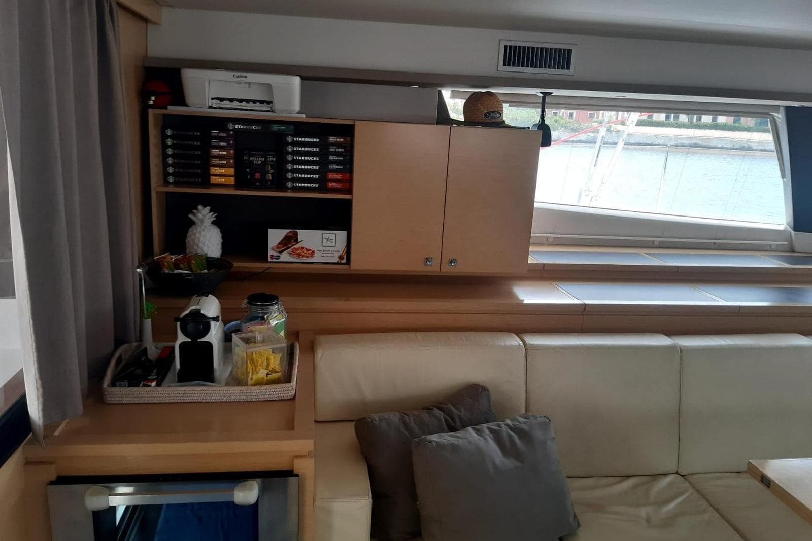 Interior of 2014 FONTAINE PAJOT 63 yacht with cozy seating and coffee station.