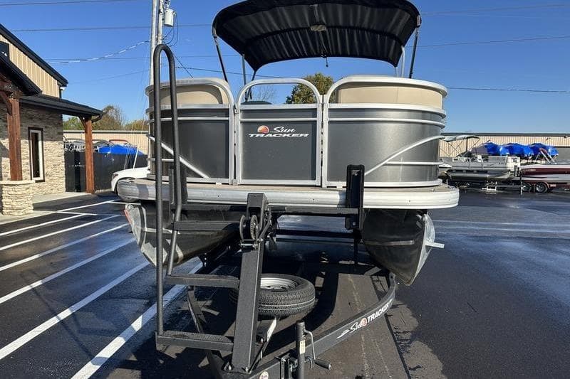 2023 Sun Tracker Party Barge 20 DLX pontoon boat on trailer, outdoor display.