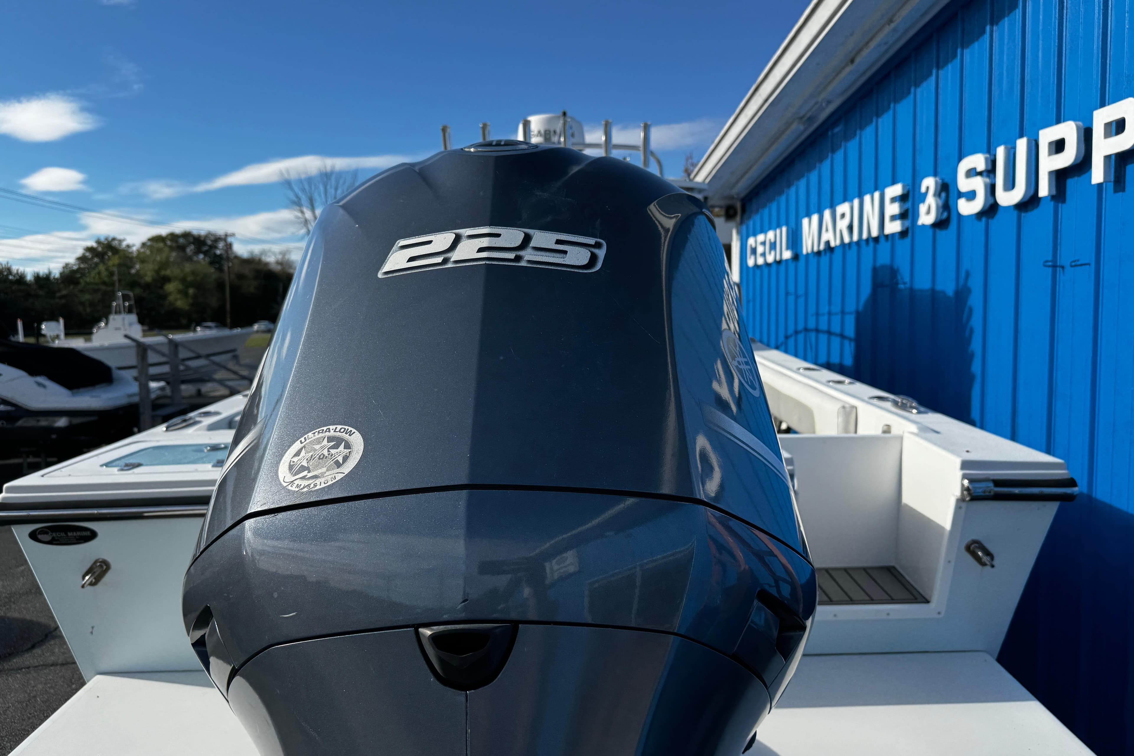 2021 Parker 2320 Sport Cabin boat with 225 engine at marine supply store.