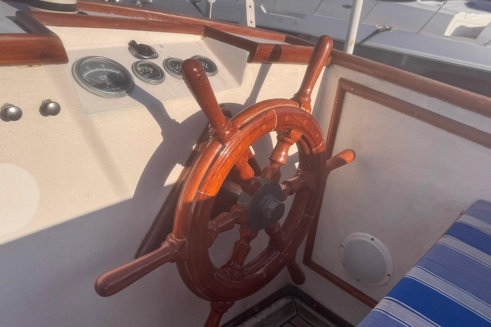 1973 Grand Banks 32 Sedan helm with wooden wheel and gauges.