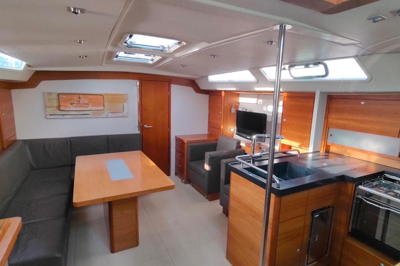 Luxurious interior of 2007 Hanse 470e yacht with modern kitchen and seating area.