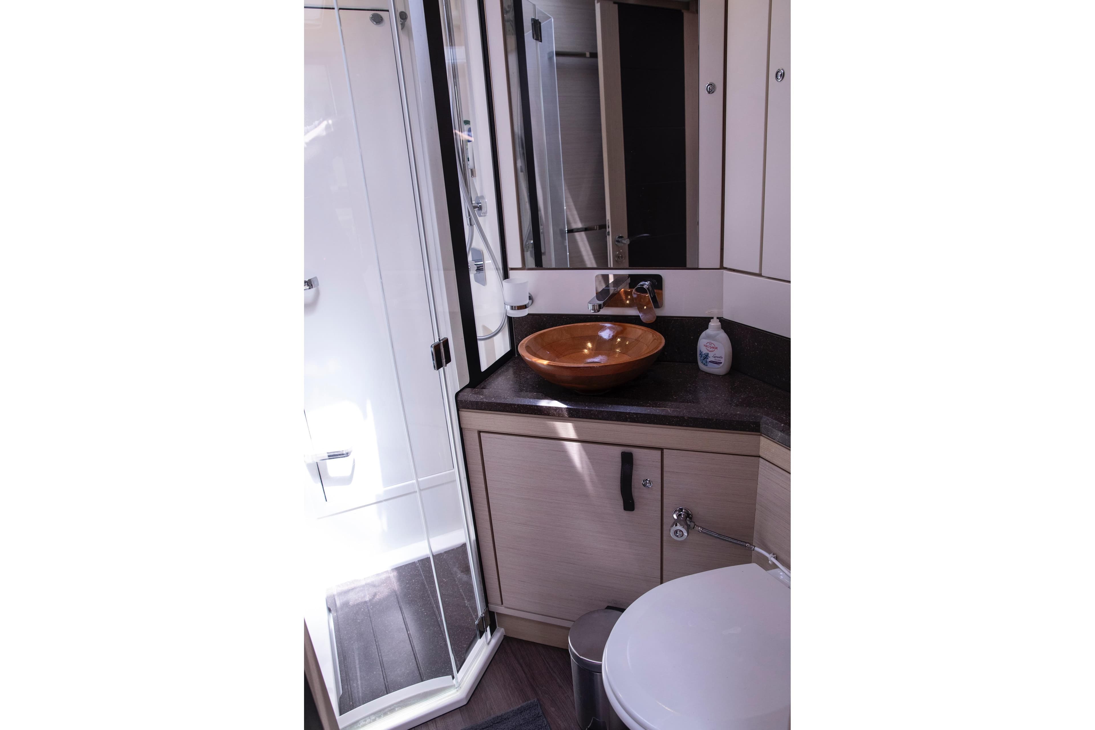 Luxurious bathroom in 2020 Jeanneau 64 yacht with modern fixtures and elegant design.