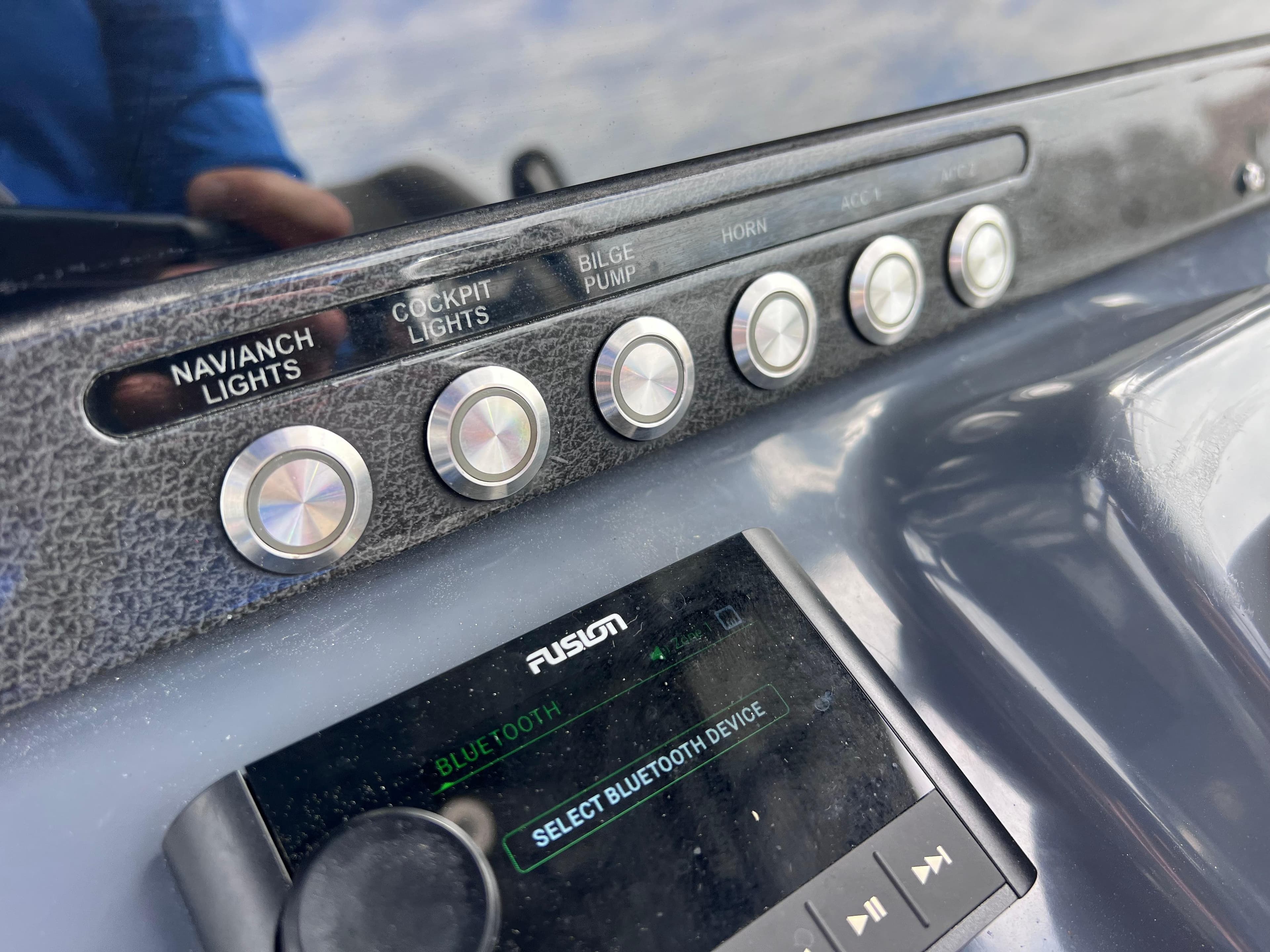 Close-up of 2020 Crevalle 26 HCO Yamaha 300 boat control panel and Fusion Bluetooth device.