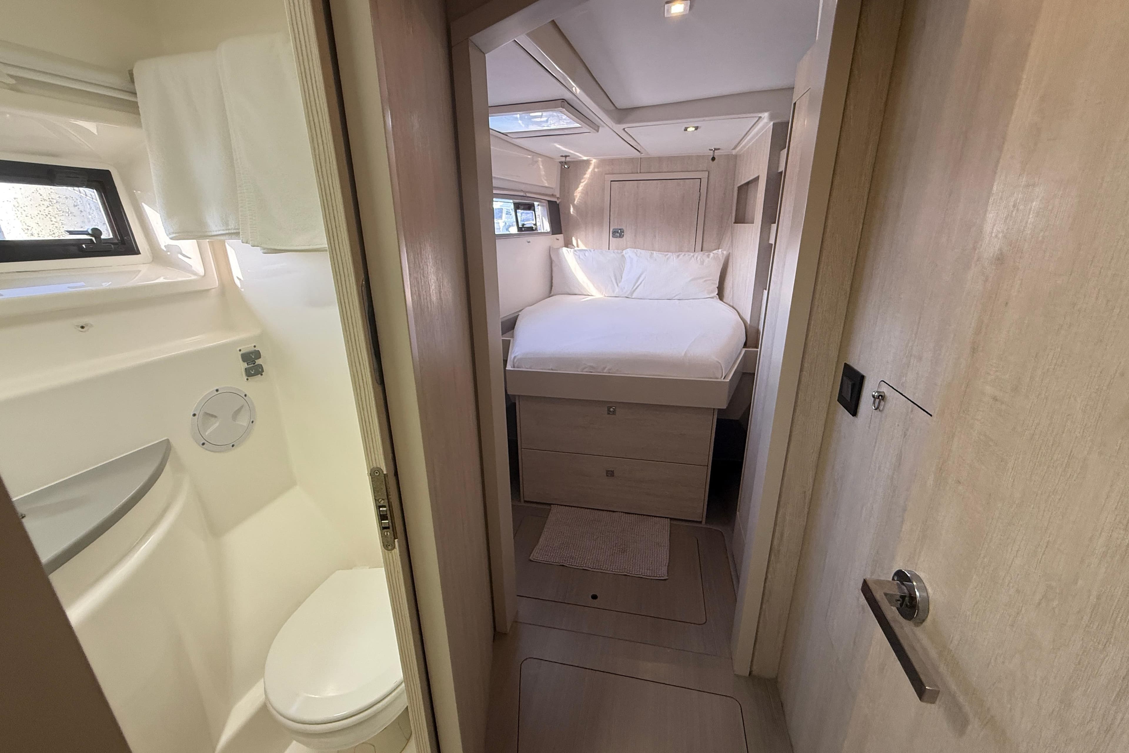 2019 Leopard 51 Powercat interior with cozy bedroom and compact bathroom.