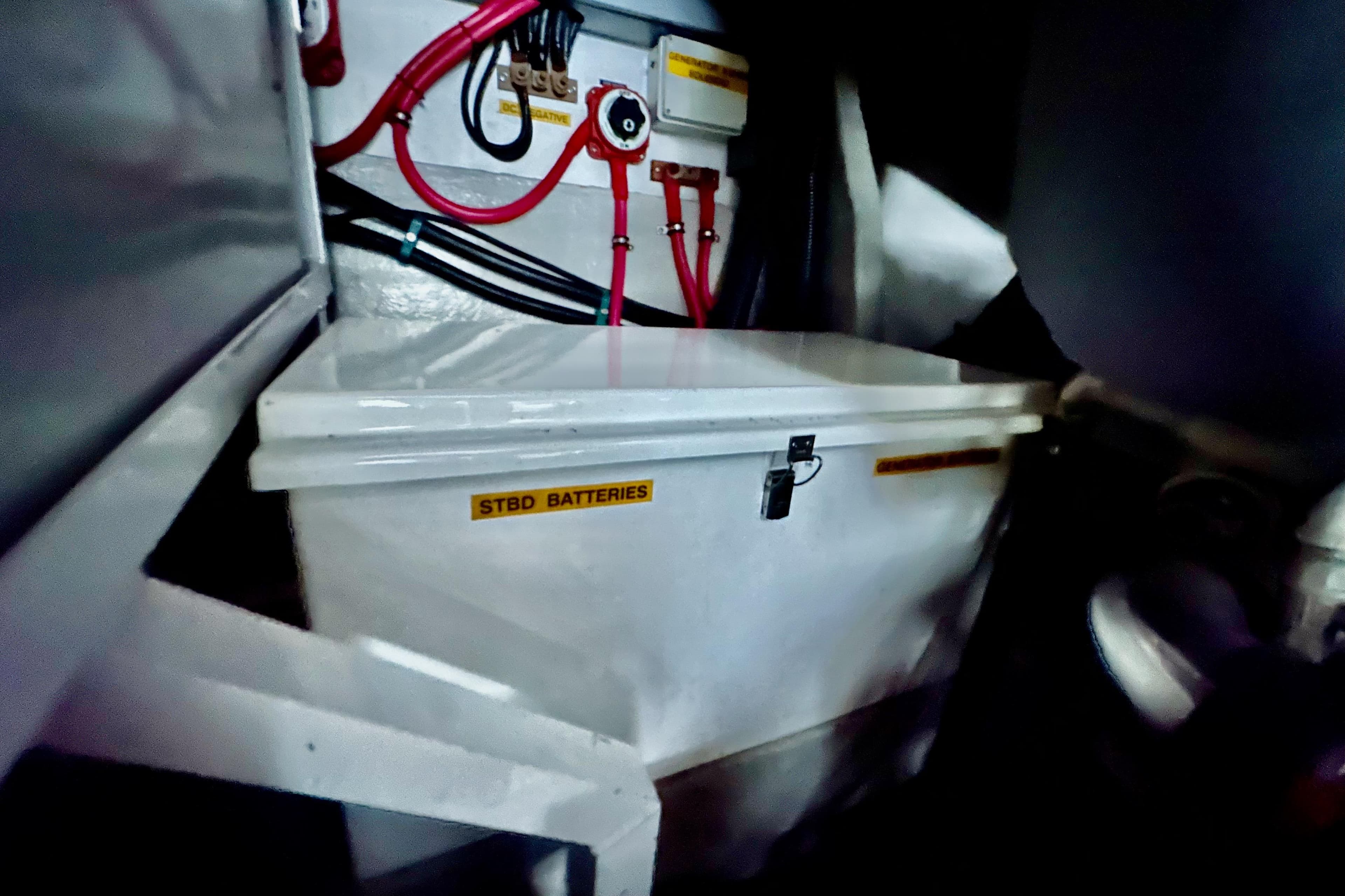 Battery compartment of 2000 Sunseeker Predator 60 yacht with labeled wiring and connections.