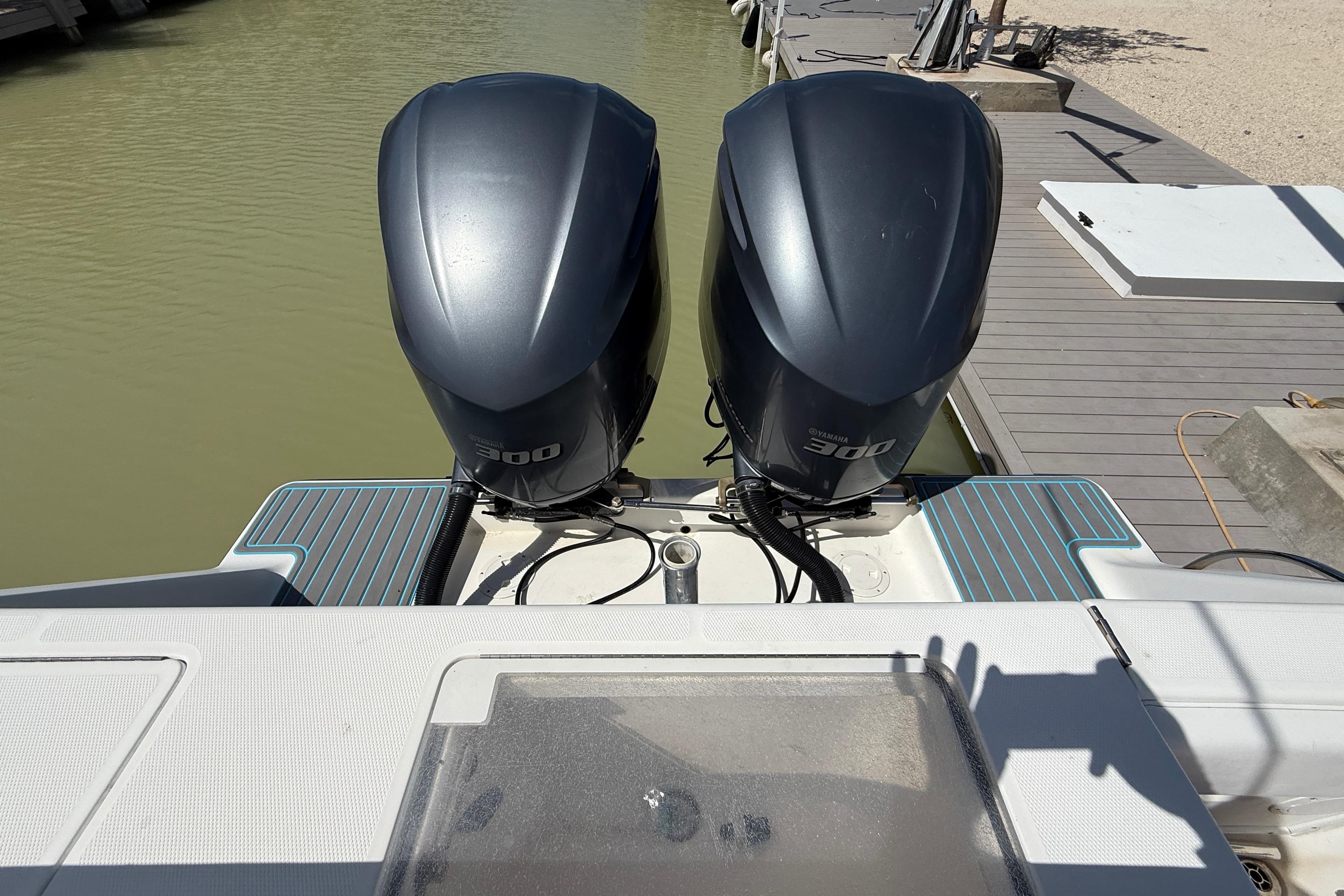 2006 SeaVee 290B boat with twin 300 horsepower outboard engines at dock.
