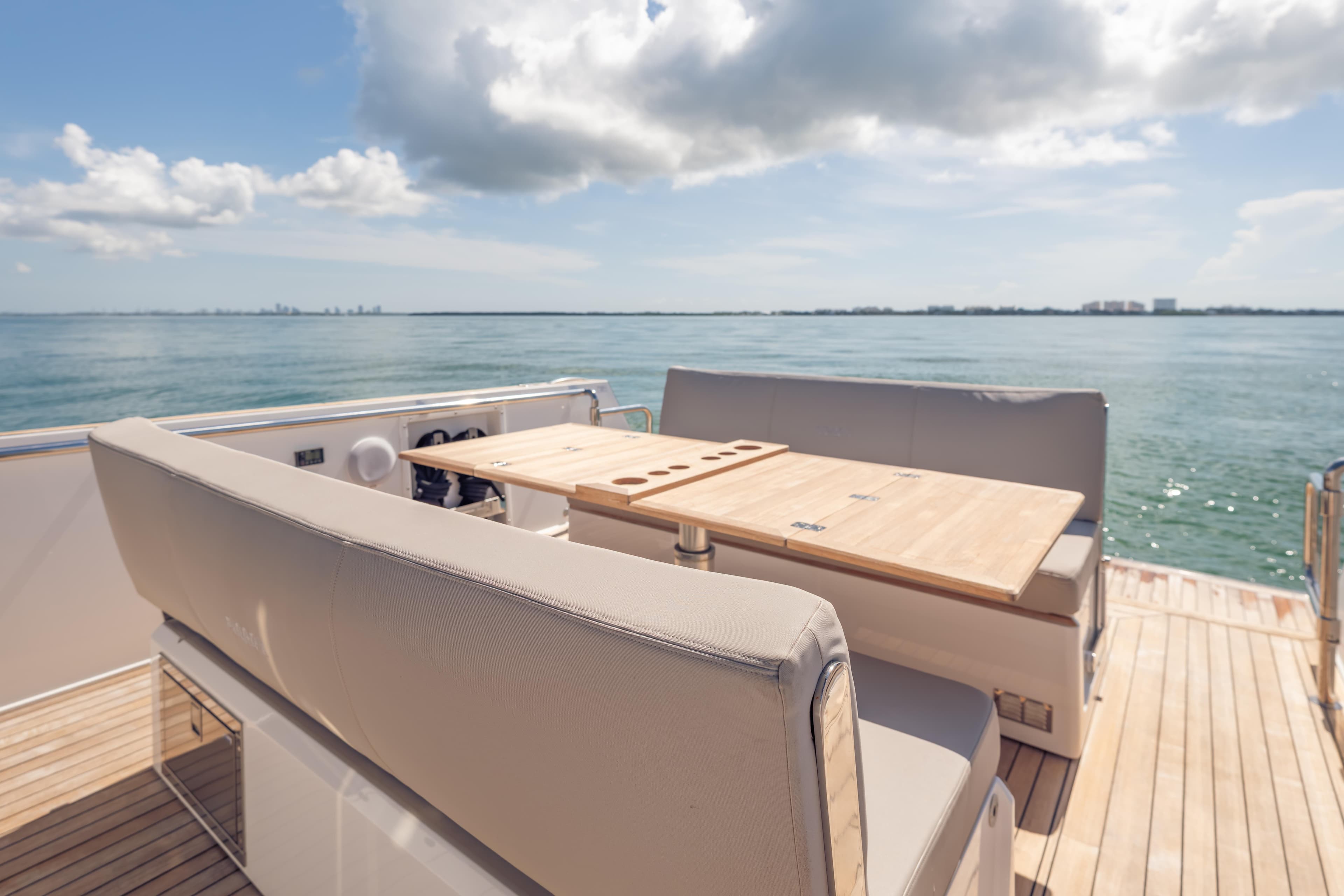 Luxury seating area on 2021 Fjord 40 Open yacht with ocean view.