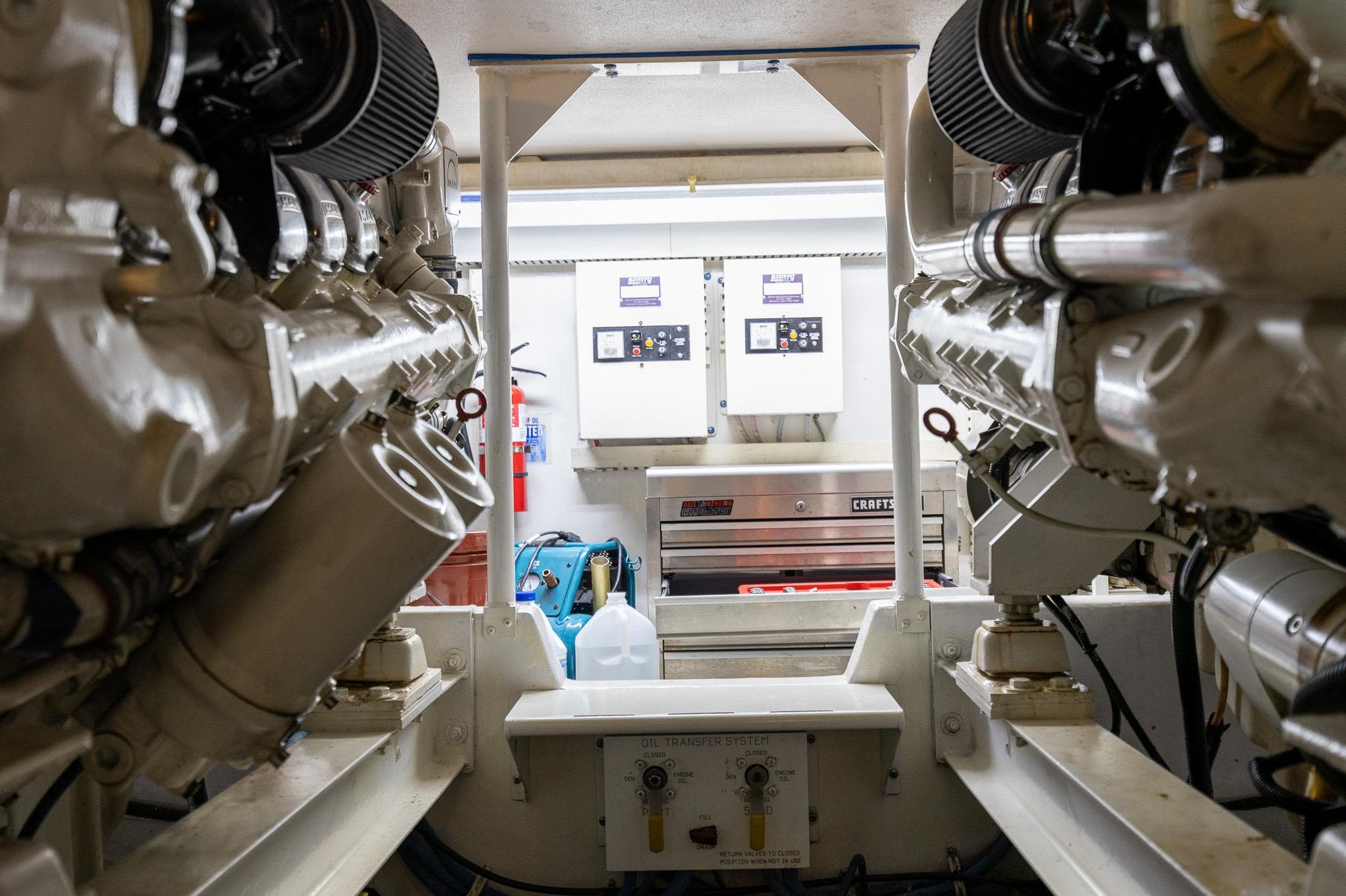 Engine room of a 1998 Viking 50 Convertible yacht, showcasing dual engines and control panels.